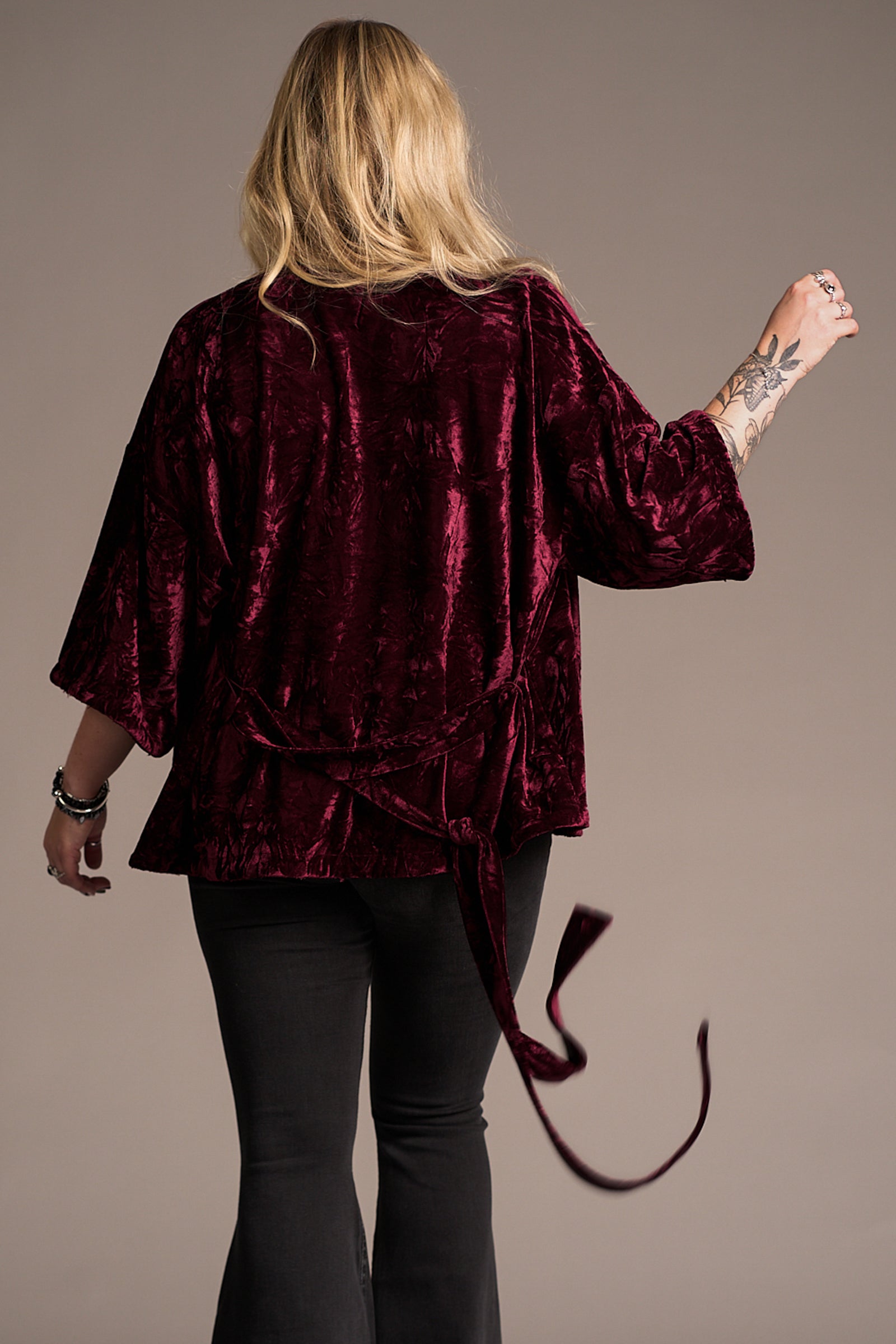 Erin showing the back of the Lana Merlot Velvet Kimono, tie detail. Stevie Nicks inspired styling studio