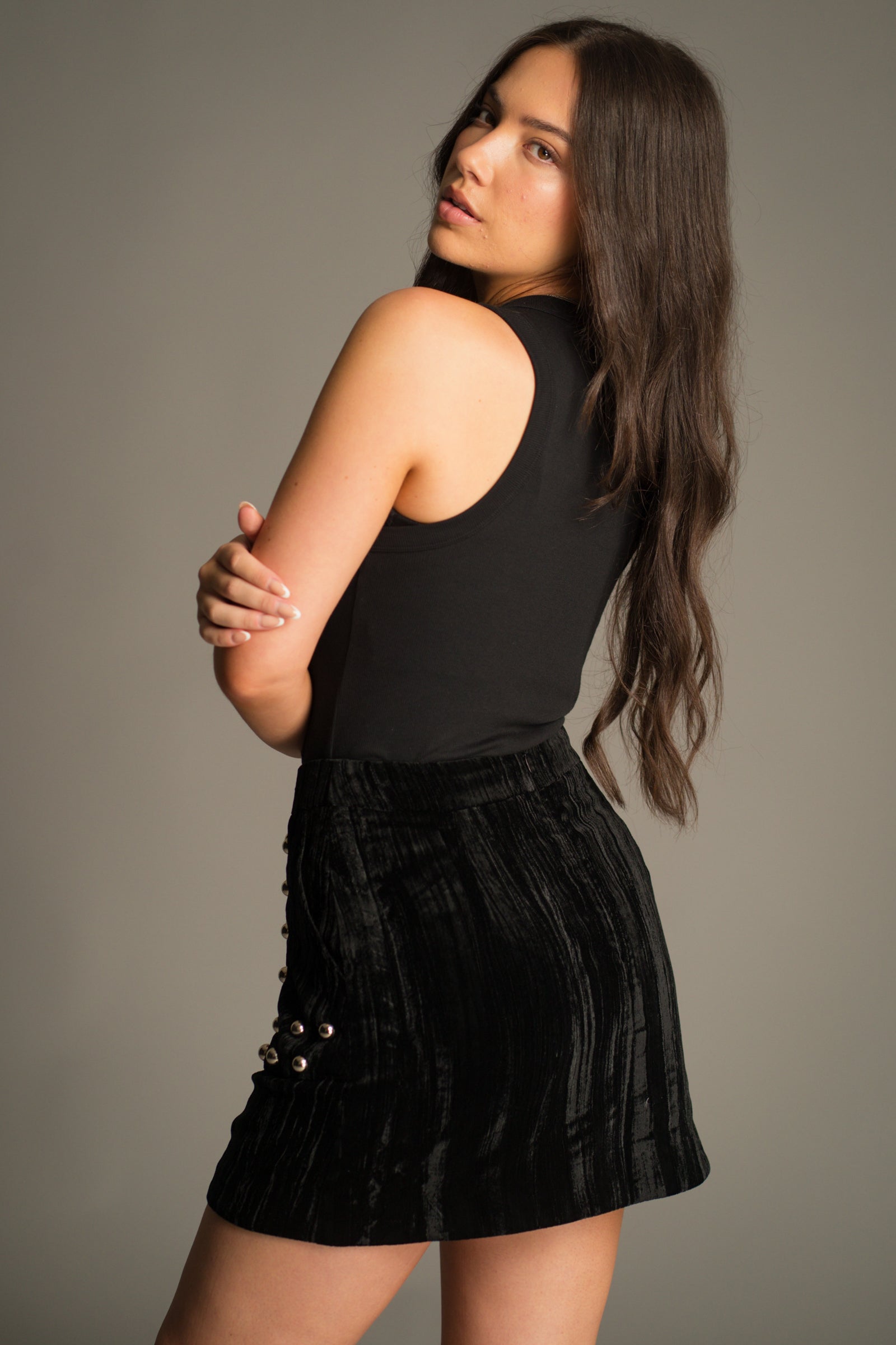 Back view of the Lennon Studded Velvet Mini Skirt showcasing the smooth velvet texture, clean waistband and flattering mini skirt shape