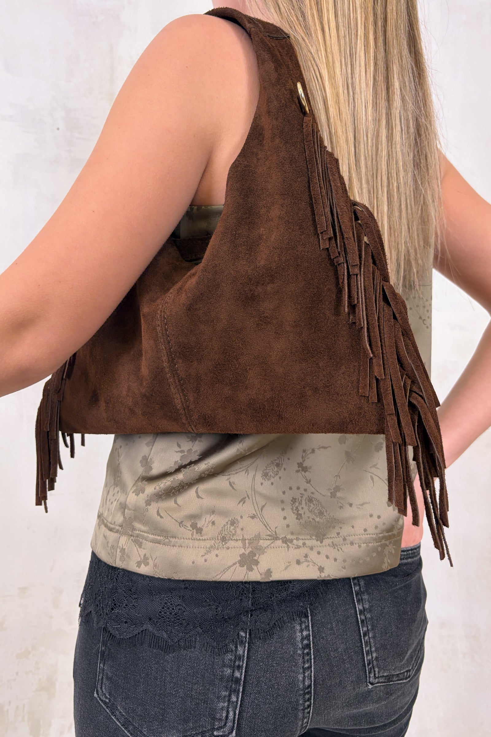 Little Lies Lila chocolate genuine suede fringed grab bag shown in an on‑body styling featuring the Iris Satin Cami and Hendrix Denim Flares, shot in the studio.