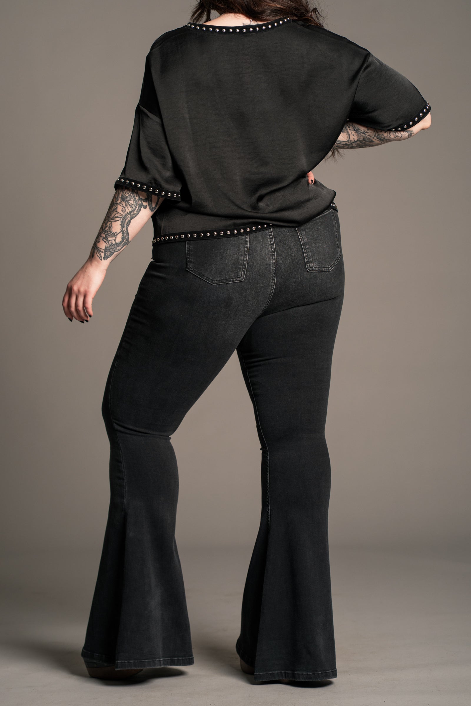 Little Lies Lita Studded Satin Tee styled with flares showing everyday rock and roll look