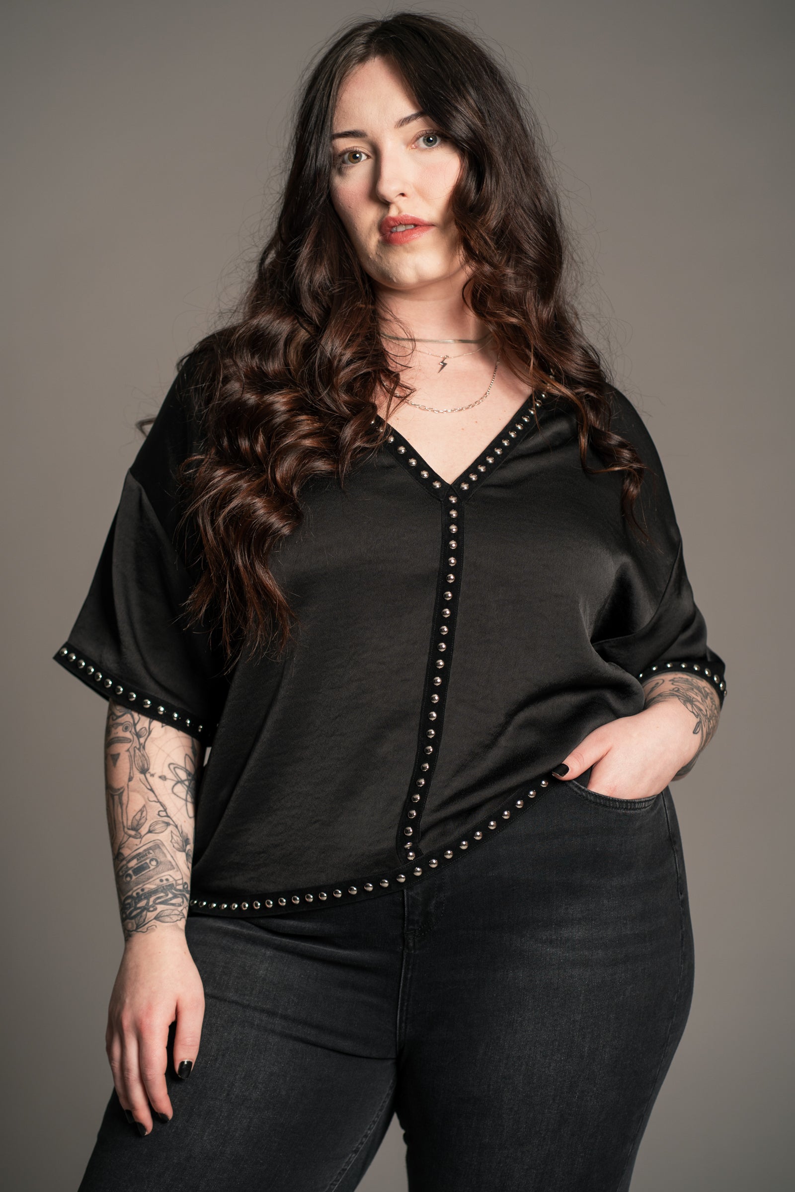 Side view of Little Lies Lita Studded Satin Tee showing velvet stud trim on sleeve and hem detail