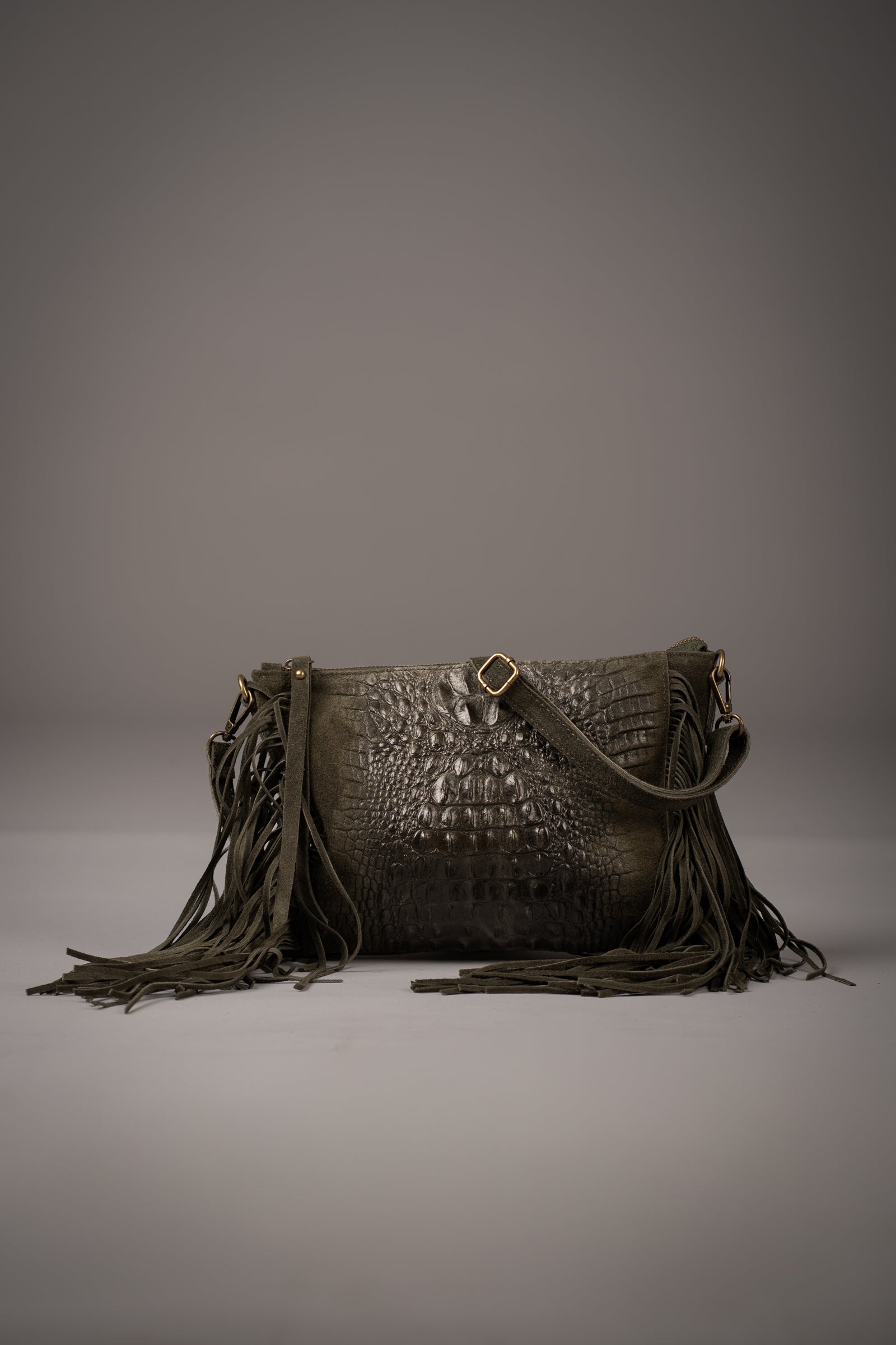 Little Lies Niska Khaki genuine suede fringed bag with embossed crocodile texture and adjustable strap, photographed in a studio setting