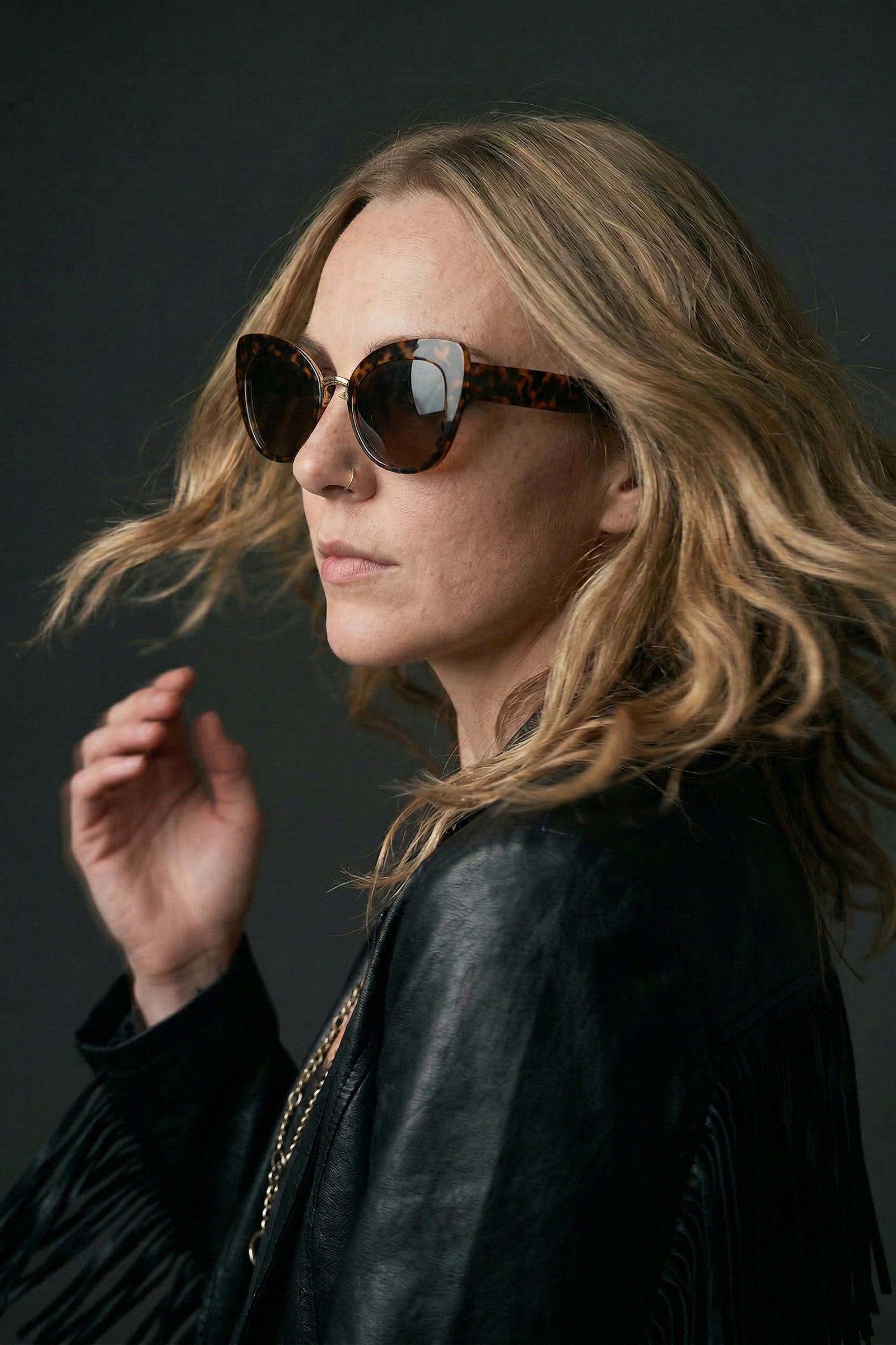 Model wearing tortoiseshell cat eye sunglasses with boho styling