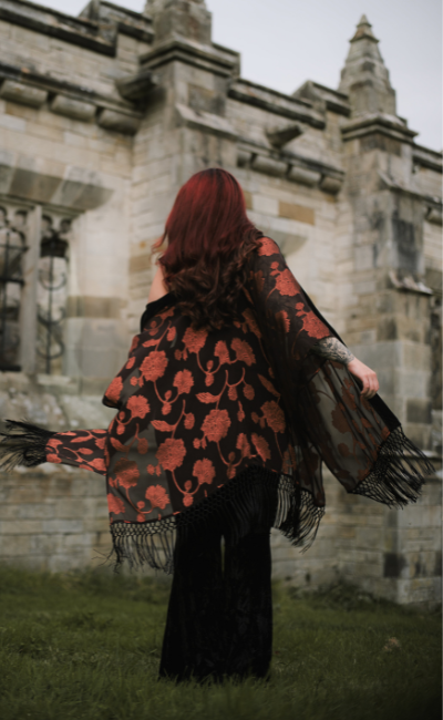 Taylor twirling in the Venus Fringed Kimono in front of gothic stone architecture in a Stevie Nicks inspired shoot