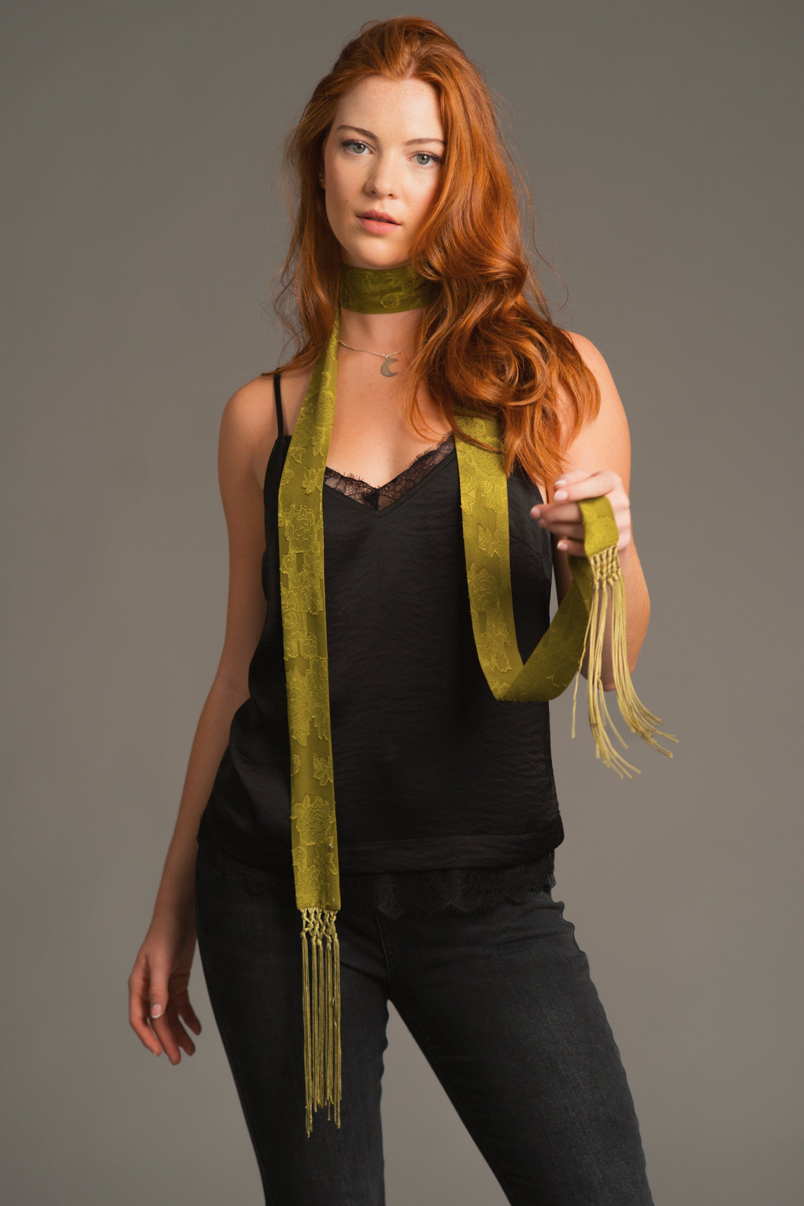 Model wearing our olive chiffon skinny scarf wrapped around neck with black Nightbird cami top.