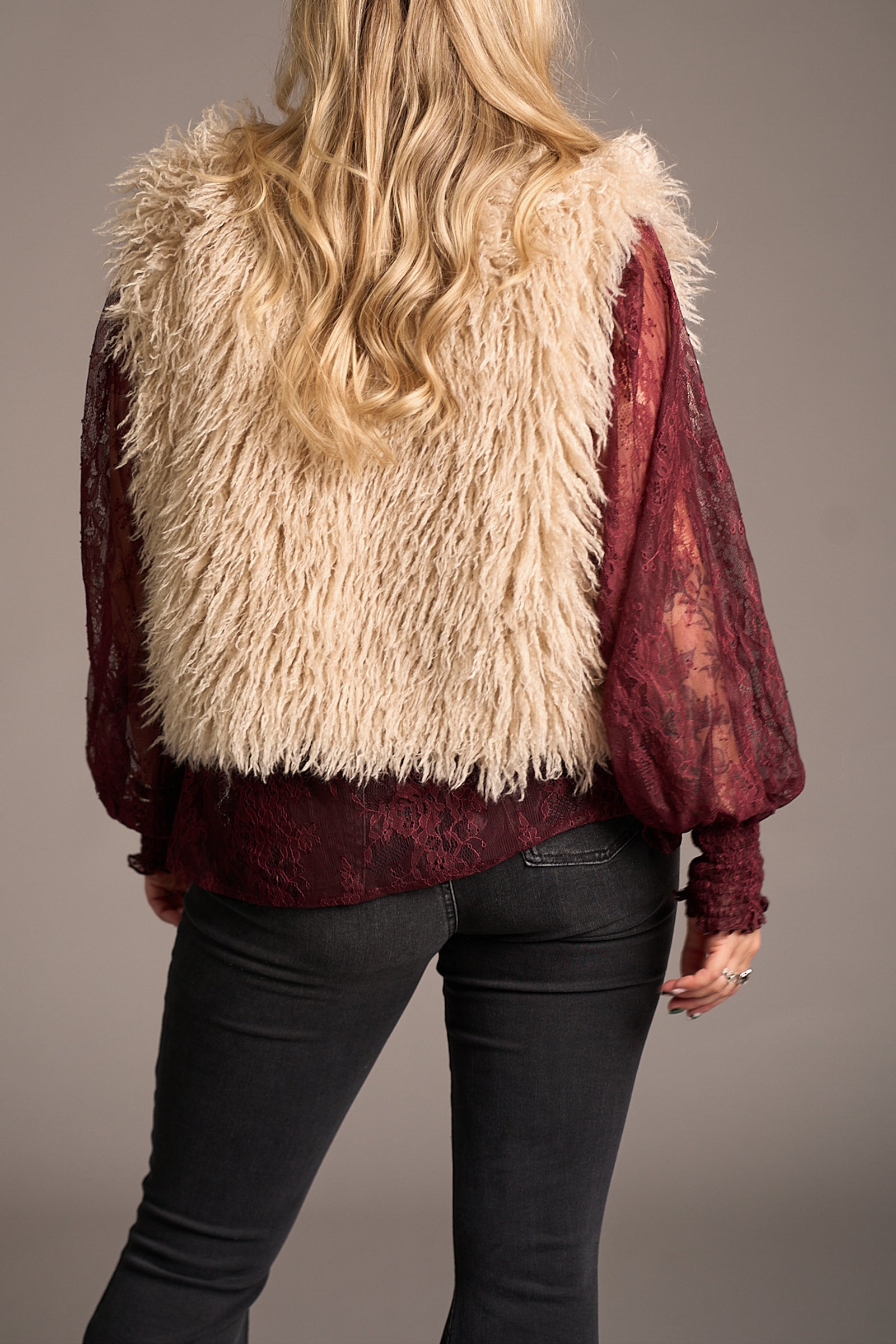 Erin showing the back the of Penny Lane Faux Mongolian Fur Gilet, Stevie Nicks inspired styling studio