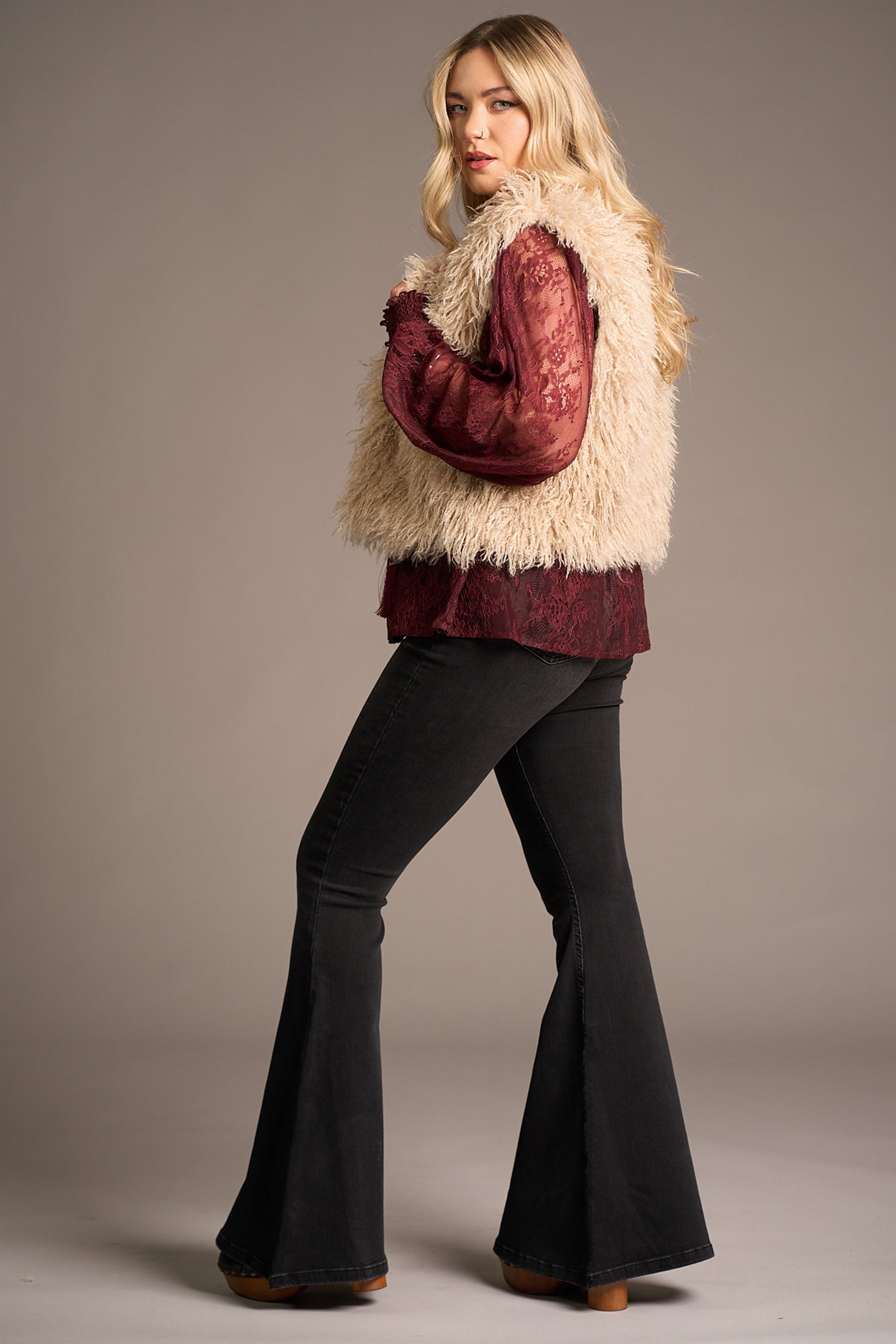 Erin showing a side view of the Penny Lane Faux Mongolian Fur Gilet, Stevie Nicks inspired styling studio