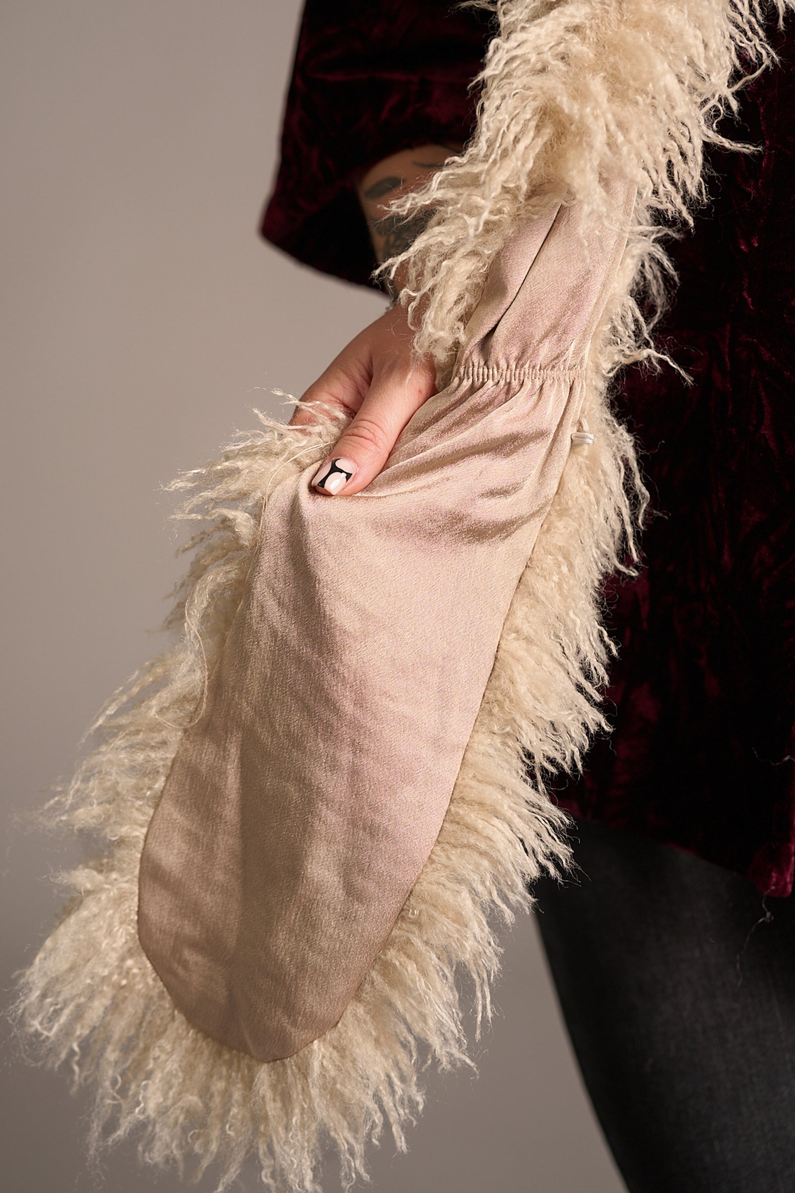Close up of Erin showcasing the Penny Lane Faux Mongolian Fur Scarf
neutral satin lining