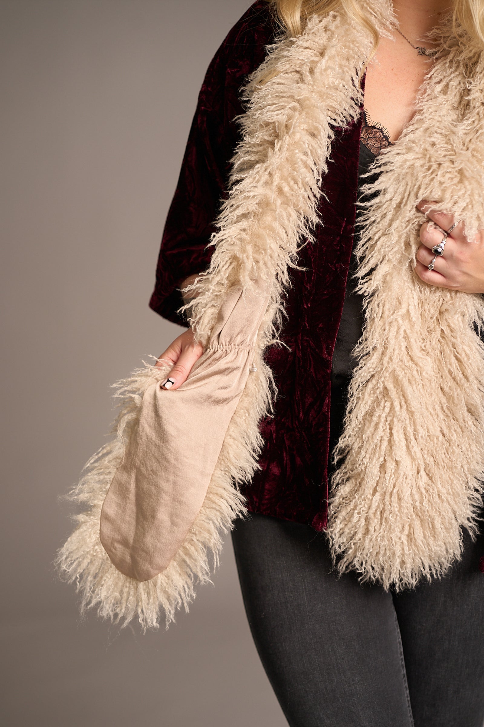 Close up of Erin showcasing the Penny Lane Faux Mongolian Fur Scarf
neutral satin lining