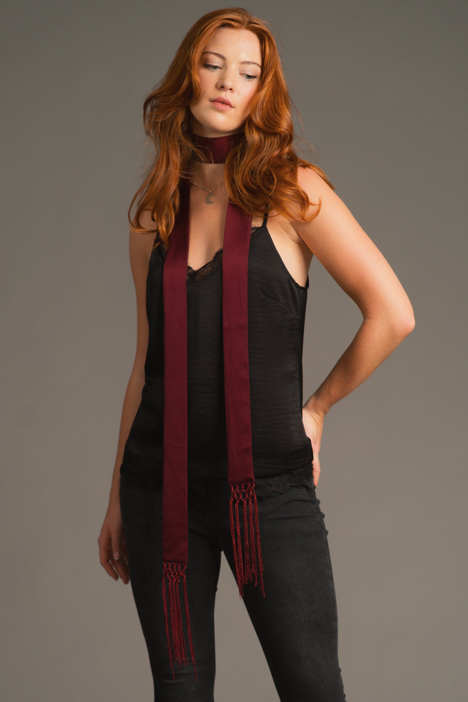 Anna wearing plum hammered satin skinny scarf with fringe trim over black Nightbird top and Denim Flares