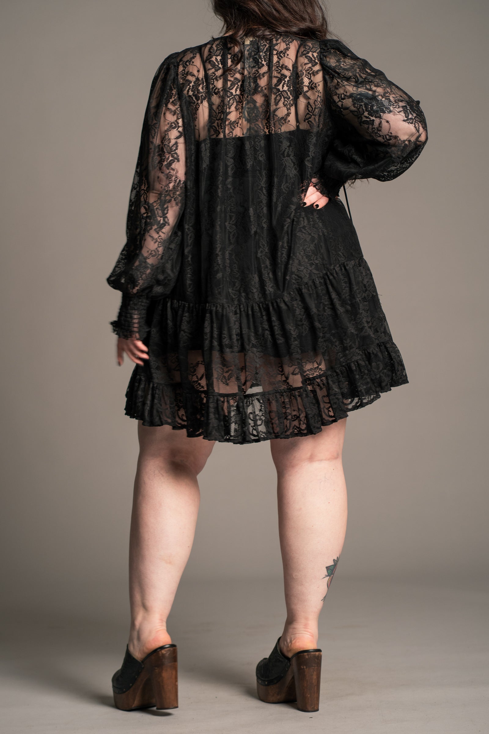 Full length view of Little Lies Rhiannon Black Lace Smock Dress styled with boots