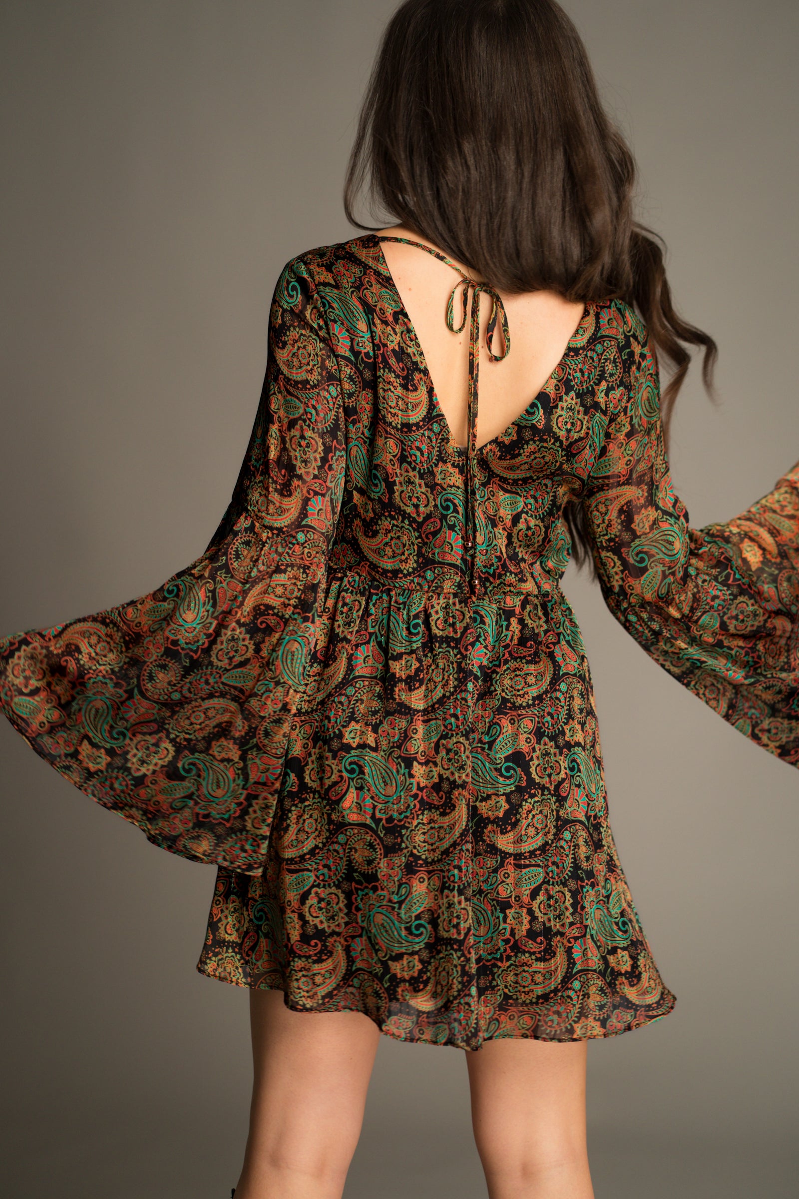 Back view of the Ringo Paisley Smock Dress showcasing the low back tie detail, flowing smock silhouette and intricate paisley print