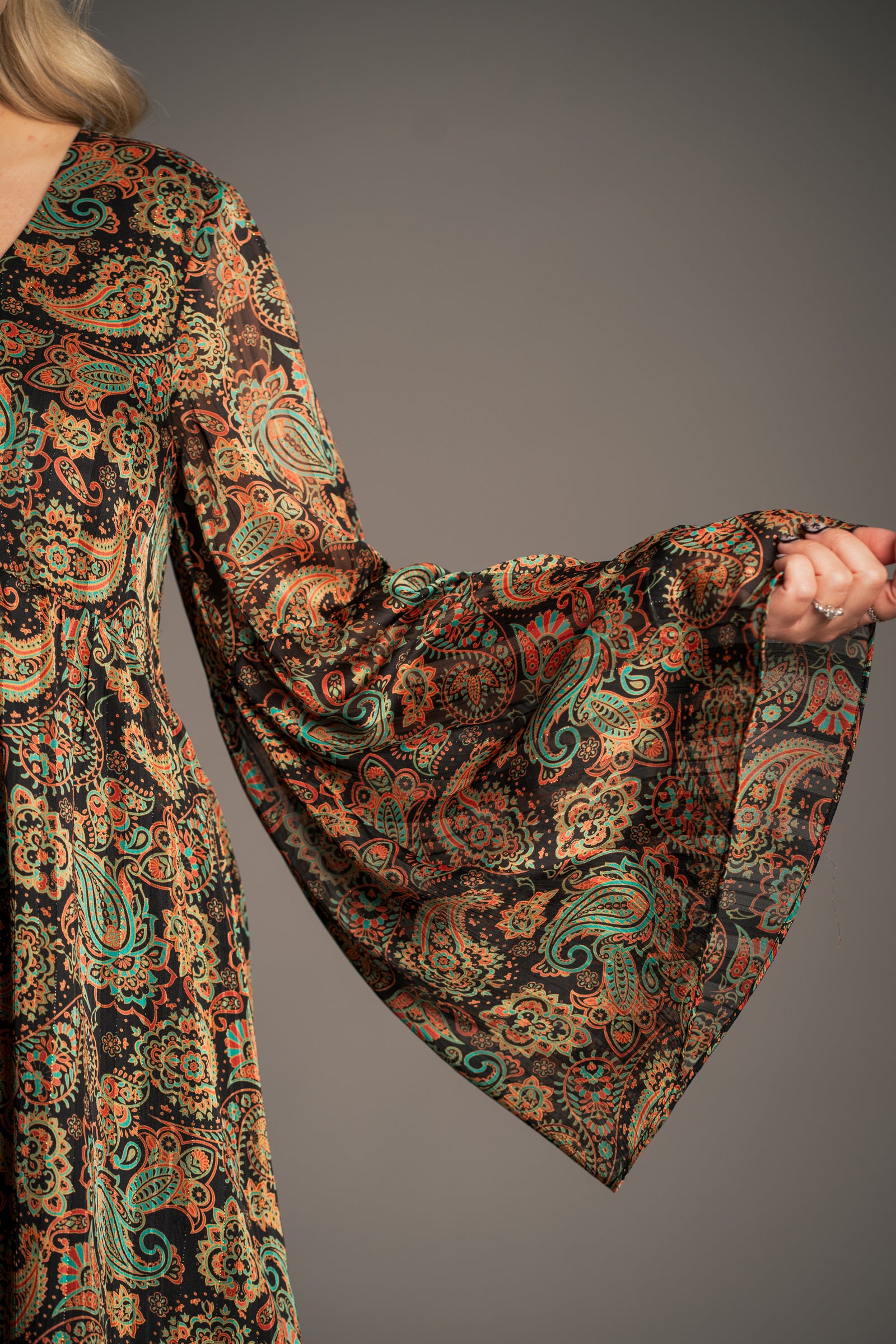 Close-up of Little Lies Ringo smock dress sleeve showing wide flared cuff and lightweight paisley print fabric