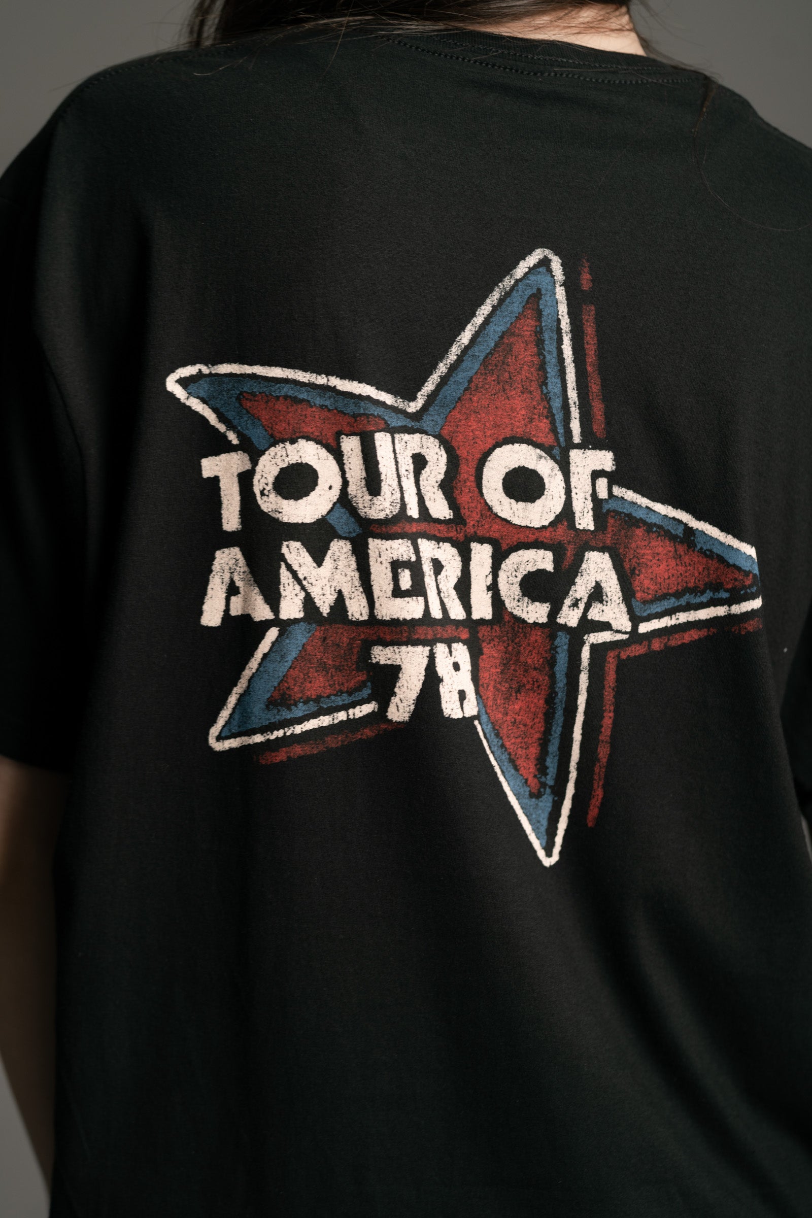 Close up of Little Lies Rolling Stones black graphic tour T-shirt with retro star ‘Tour of America ’78’ print on the back