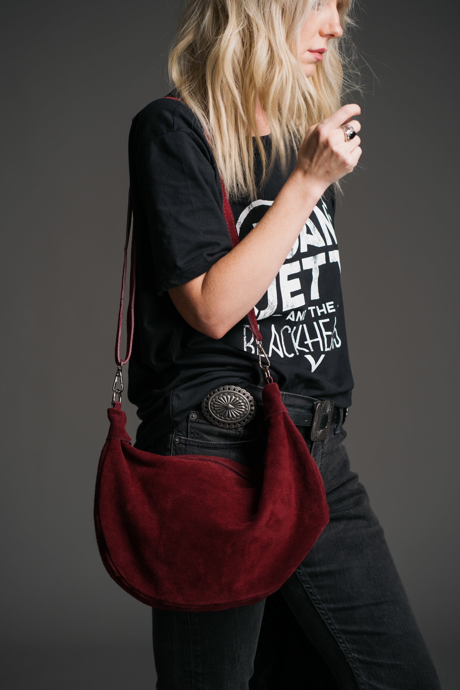 Sienna Oxblood Genuine Suede Sling Bag worn crossbody with a black graphic band tee and dark denim.