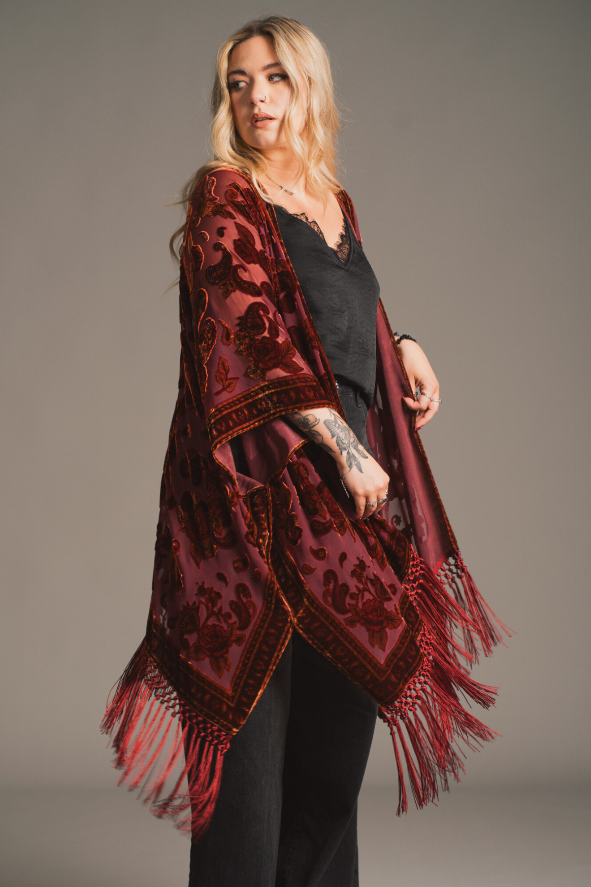 Erin wearing the Stevie Plum Paisley devore floral fringed kimono with Black satin Nightbird Cami top.