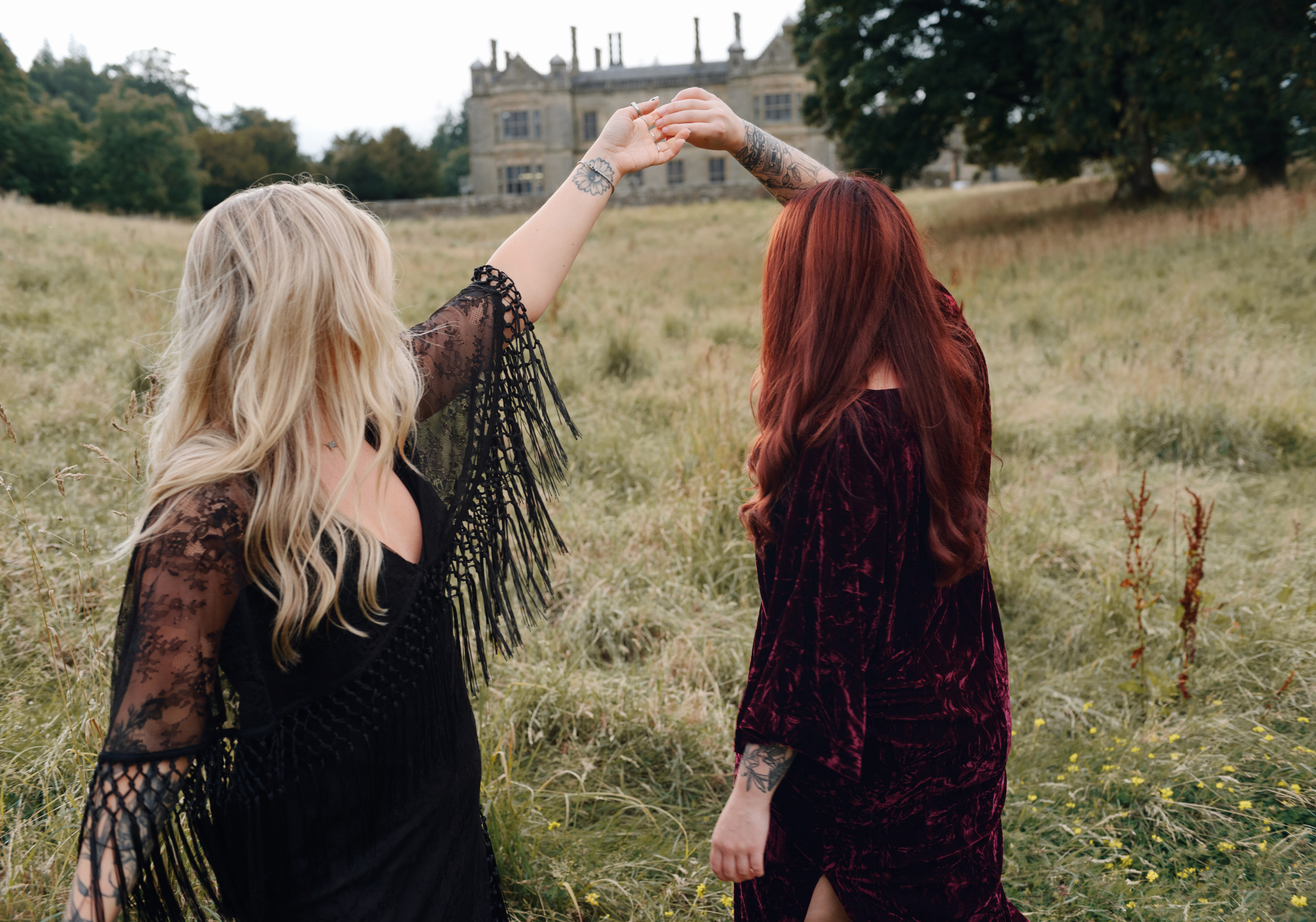 Erin wears Tango in the Night Lace Midi Dress, Taylor wears Rumours Merlot Velvet Midi Dress on Stevie Nicks inspired shoot outside a vintage manor