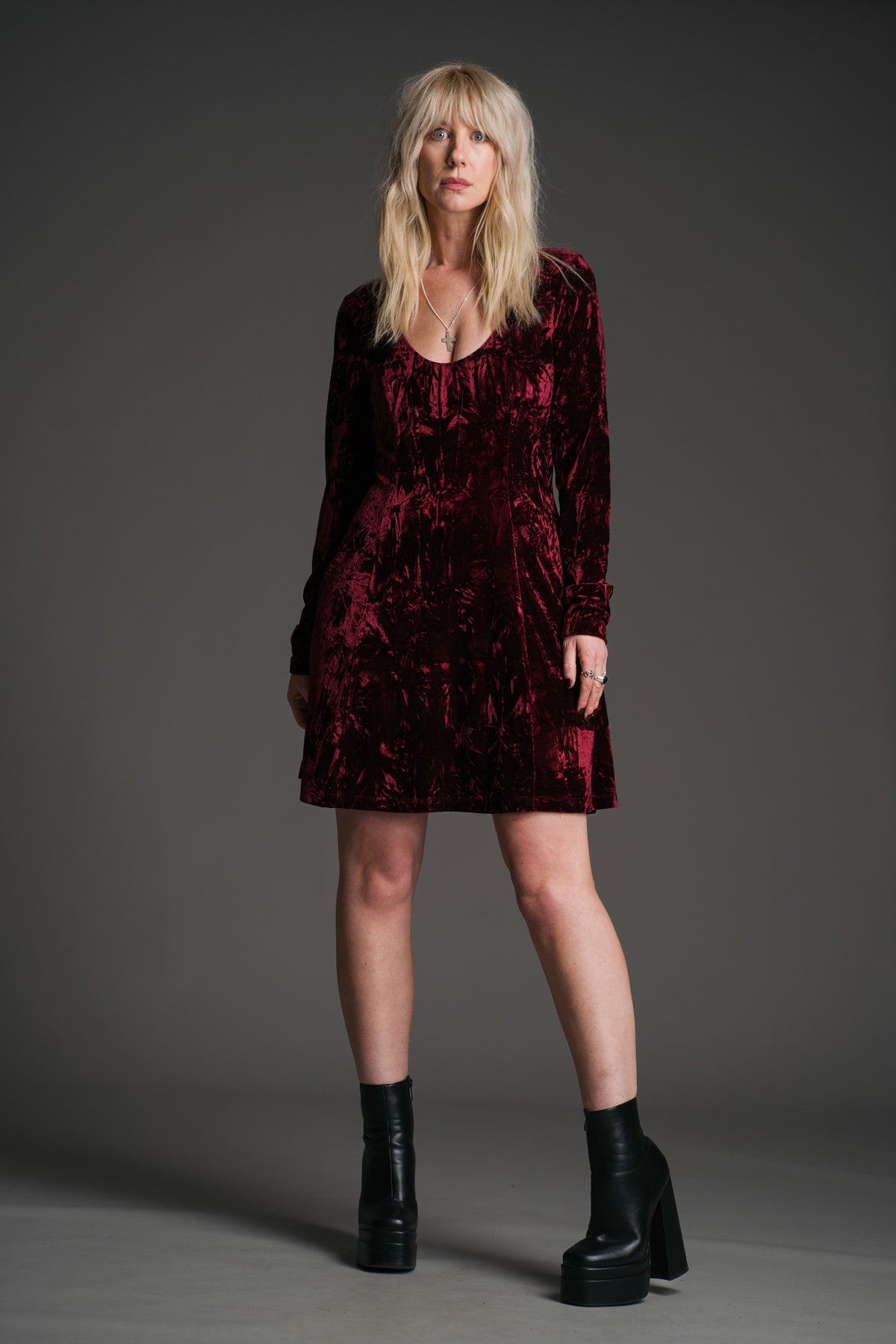 Sara wearing the Little Lies Sweet Jane Merlot crushed velvet long‑sleeve mini dress in a studio setting