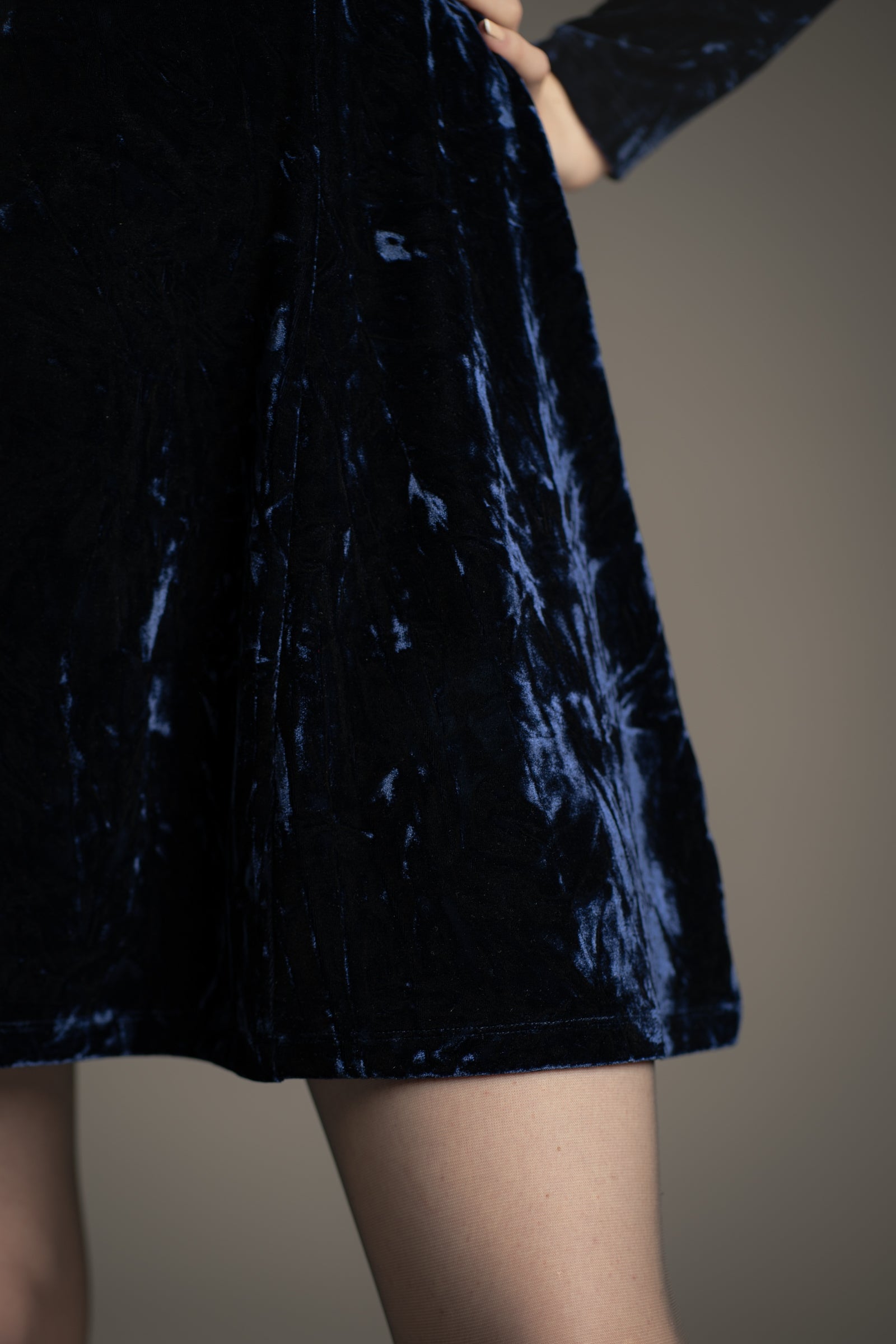Close-up of hem detail on Little Lies Sweet Jane Midnight Crushed Mini Dress in deep blue velvet
