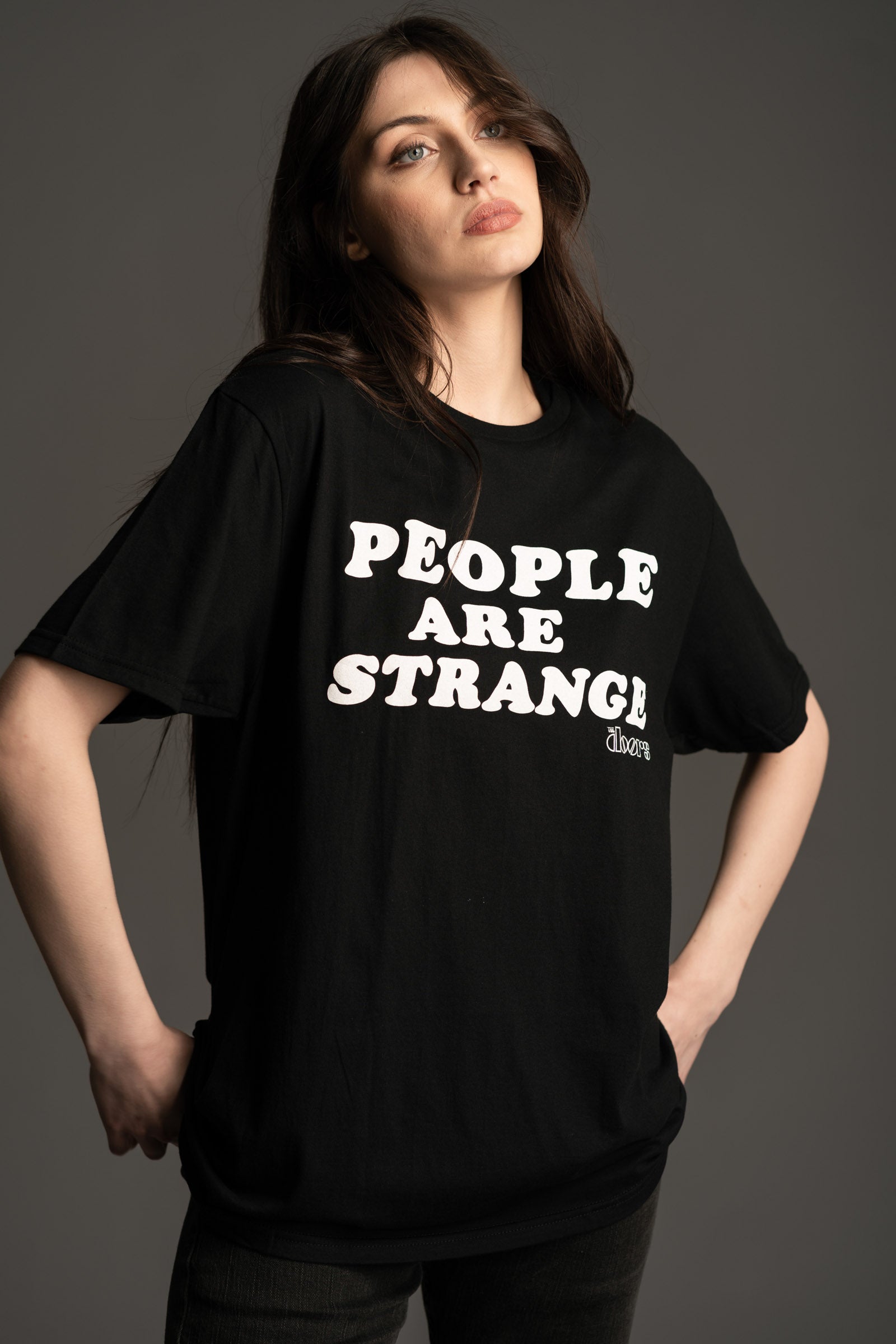 Andie wears Little Lies The Doors black graphic t-shirt with 'People Are Strange' slogan