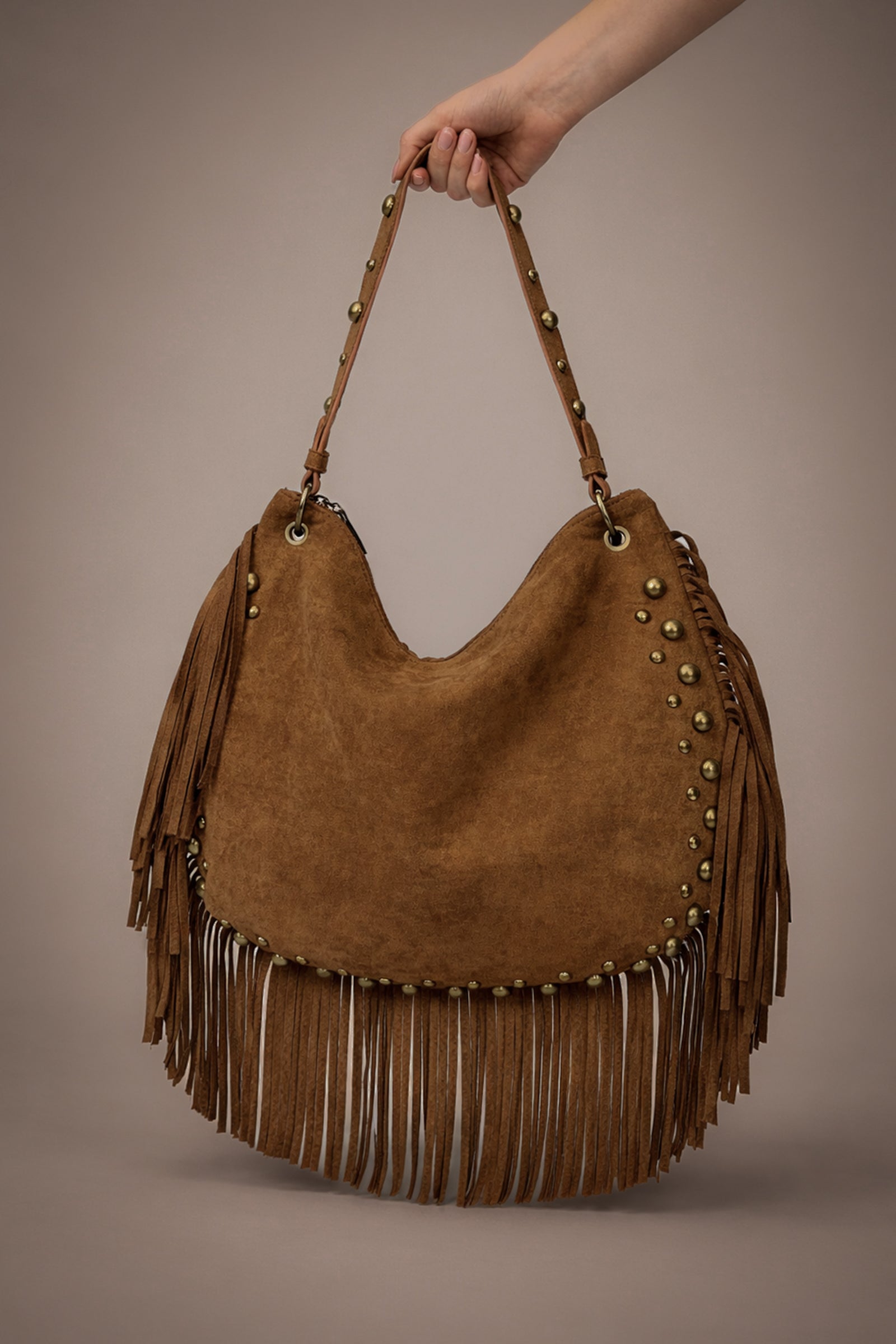 Little Lies Willow Slouchy tan faux suede studded fringe bag in studio setting.