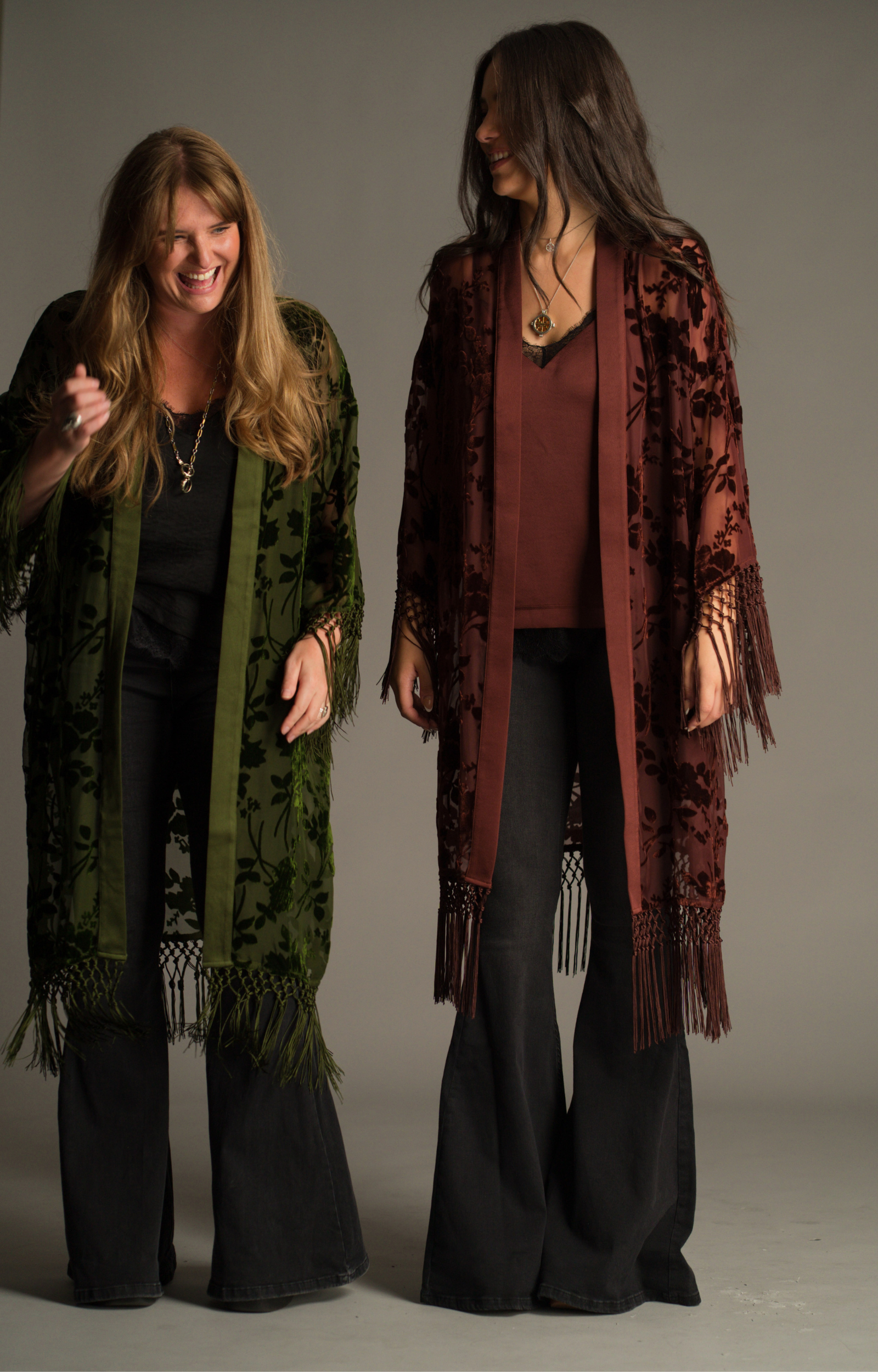 On set Autumn campaign, showcasing Little Lies Dakota olive and rust devore kimonos with sheer floral velvet detailing and tassel trim in studio setting.