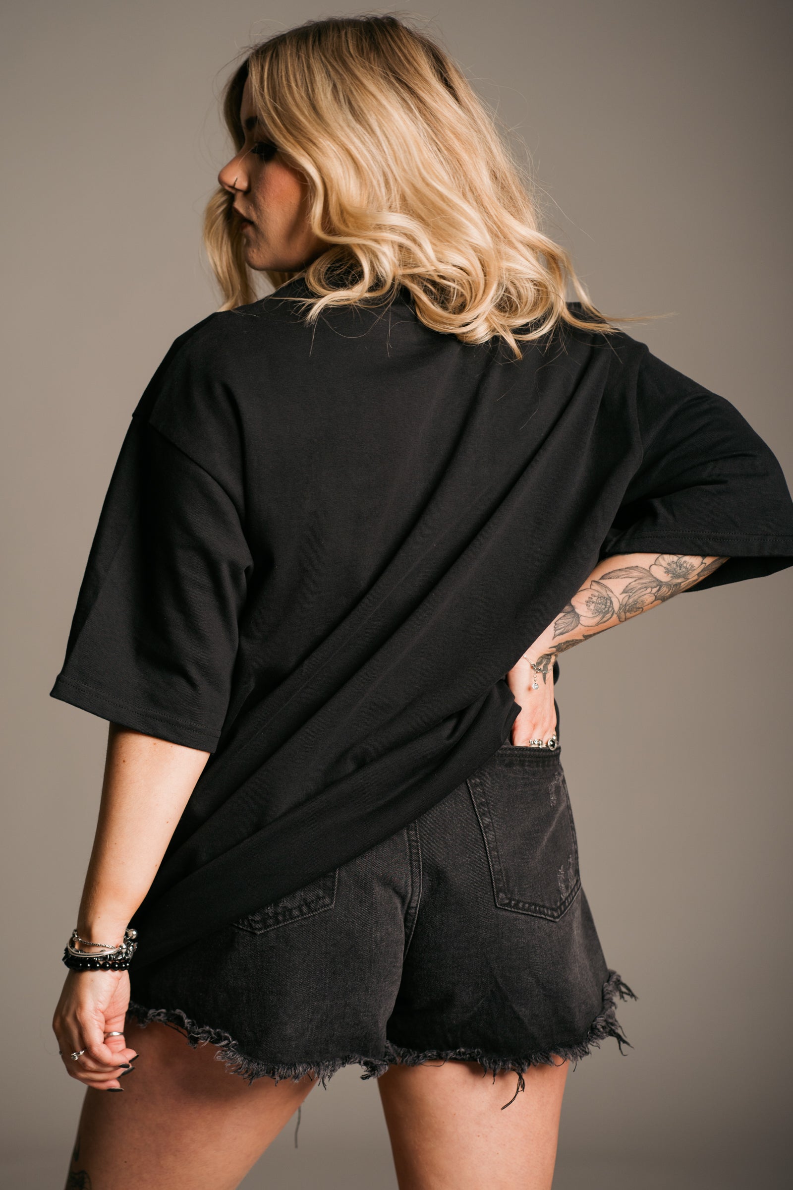 Back view of Fleetwood Mac Floral Oversize Band Tee on black premium heavyweight base