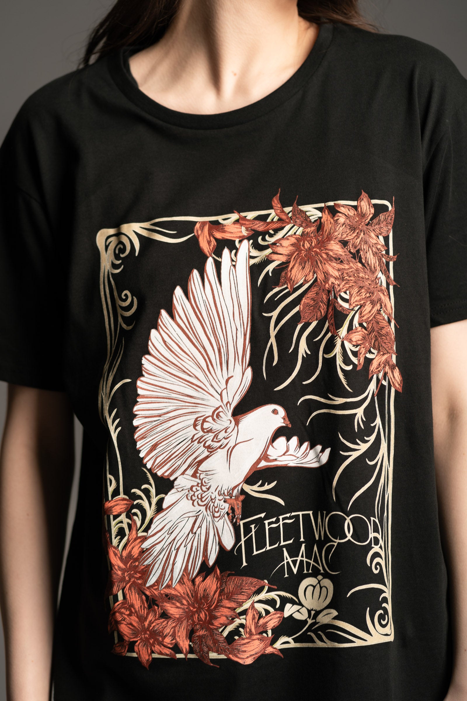 Close-up of floral dove graphic on black Fleetwood Mac Dove Band Tee from Little Lies