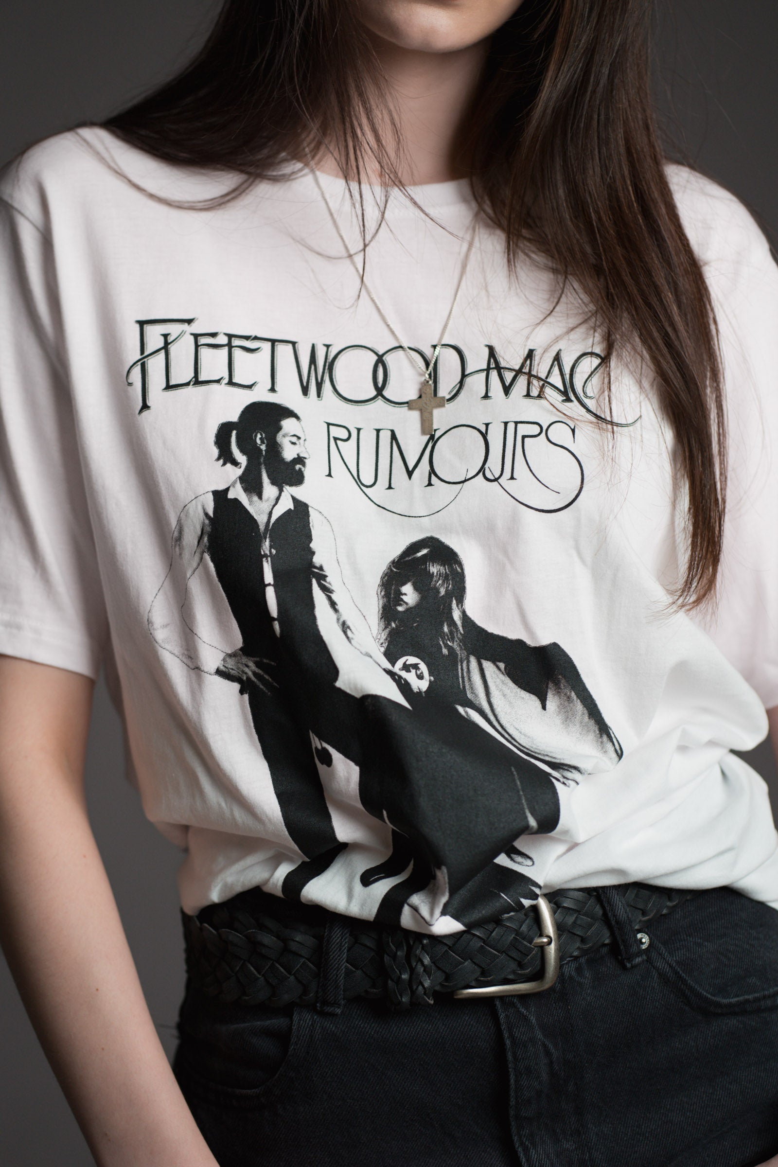 Little Lies Fleetwood Mac Rumours white retro band tee with black graphic print styled with black braided belt and dark jeans, vintage rock-inspired boho festival outfit essential
