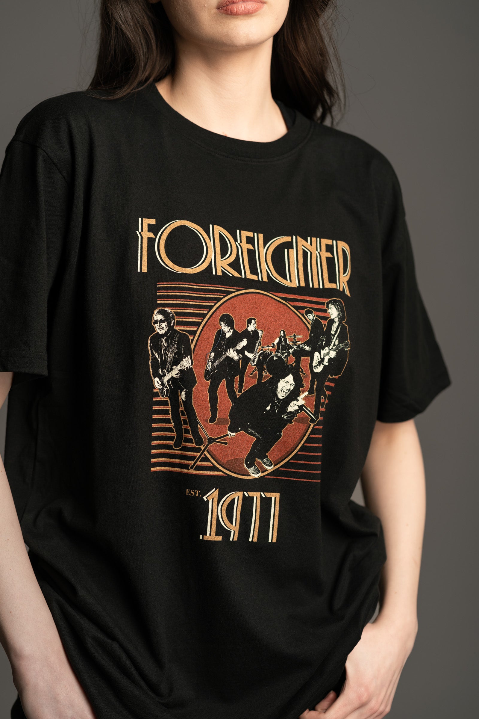 Unisex black standard fit Foreigner band t‑shirt by Little Lies featuring retro 1977 rock graphic.