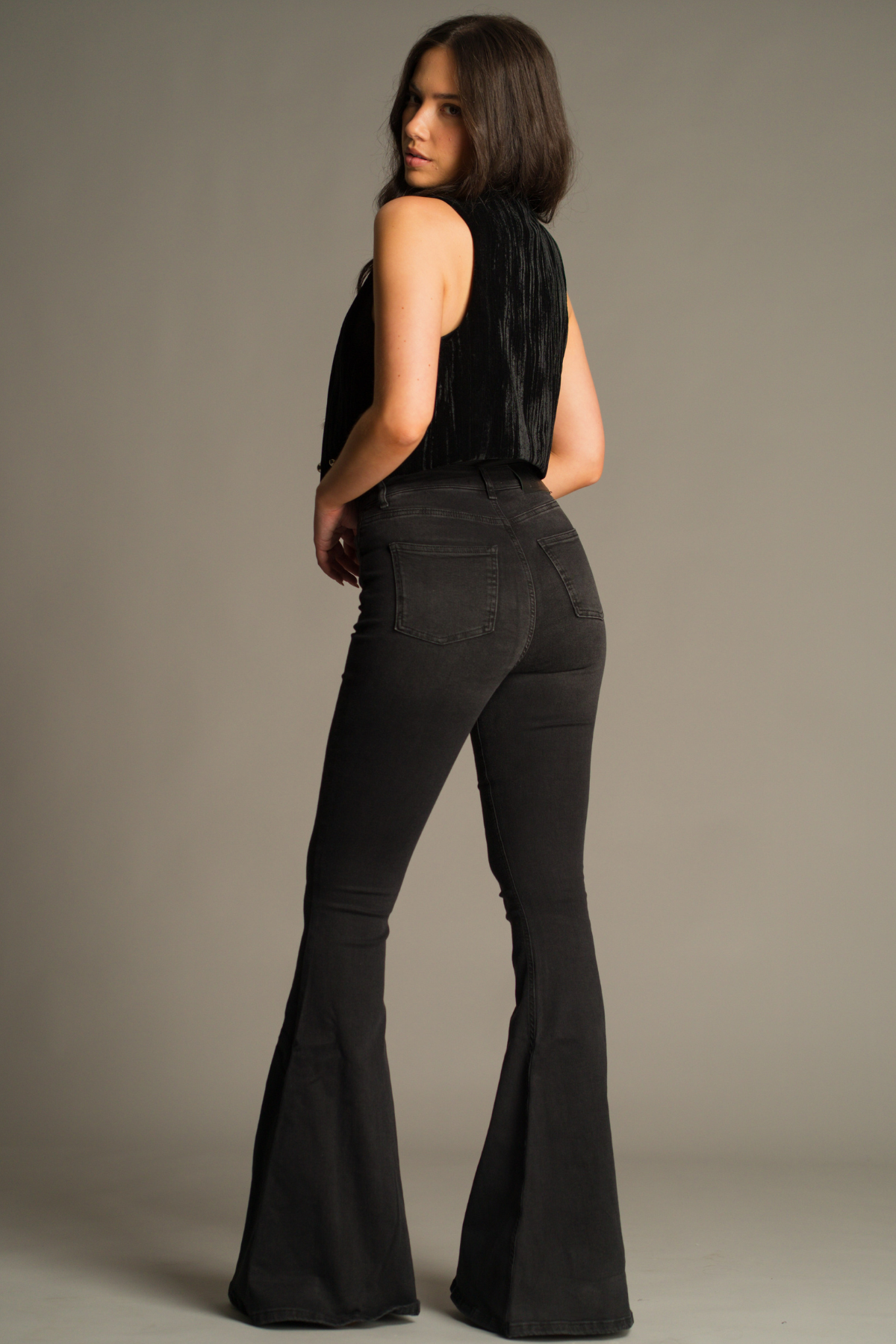 Back view of Hendrix Denim Flares in washed black with rear patch pockets, high-waisted fit and dramatic flare leg