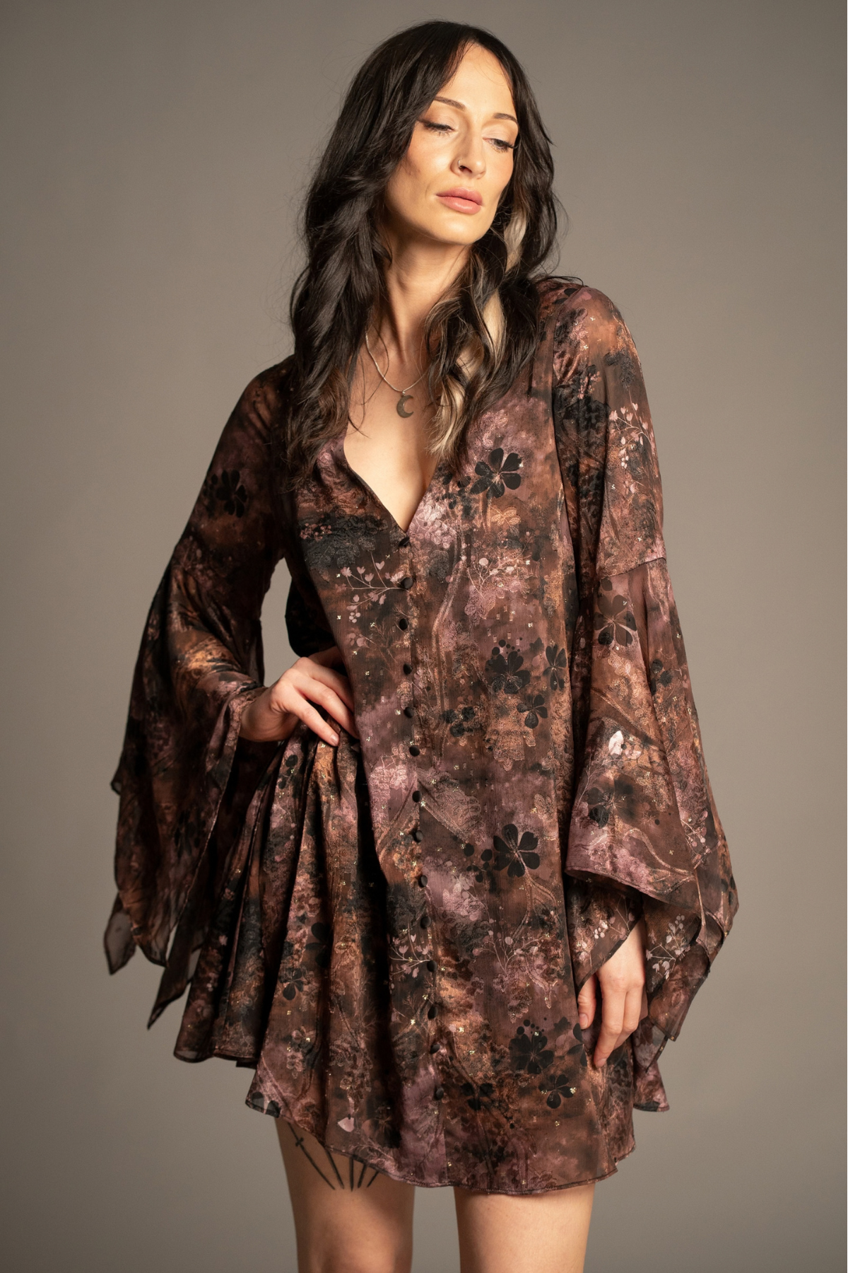 Practical Magic mini dress with vintage-inspired floral print, deep V-neckline and flowing hanky sleeves front view