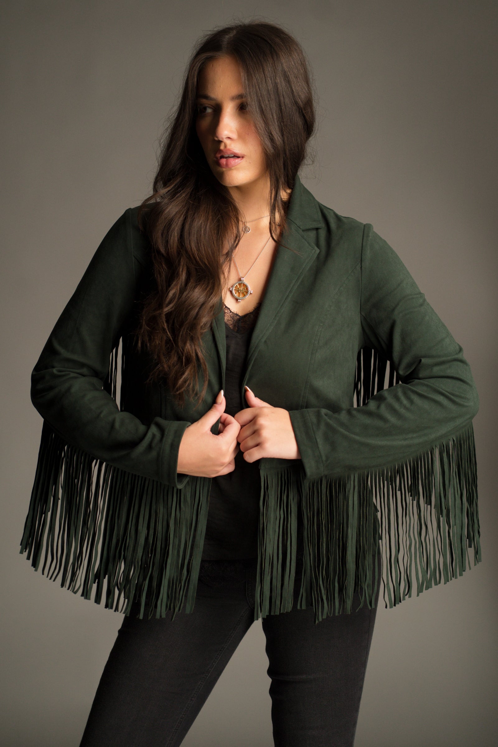 Front view showing dramatic sleeve fringe details and suede texture on the Ivy Emerald Green Fringed Jacket.