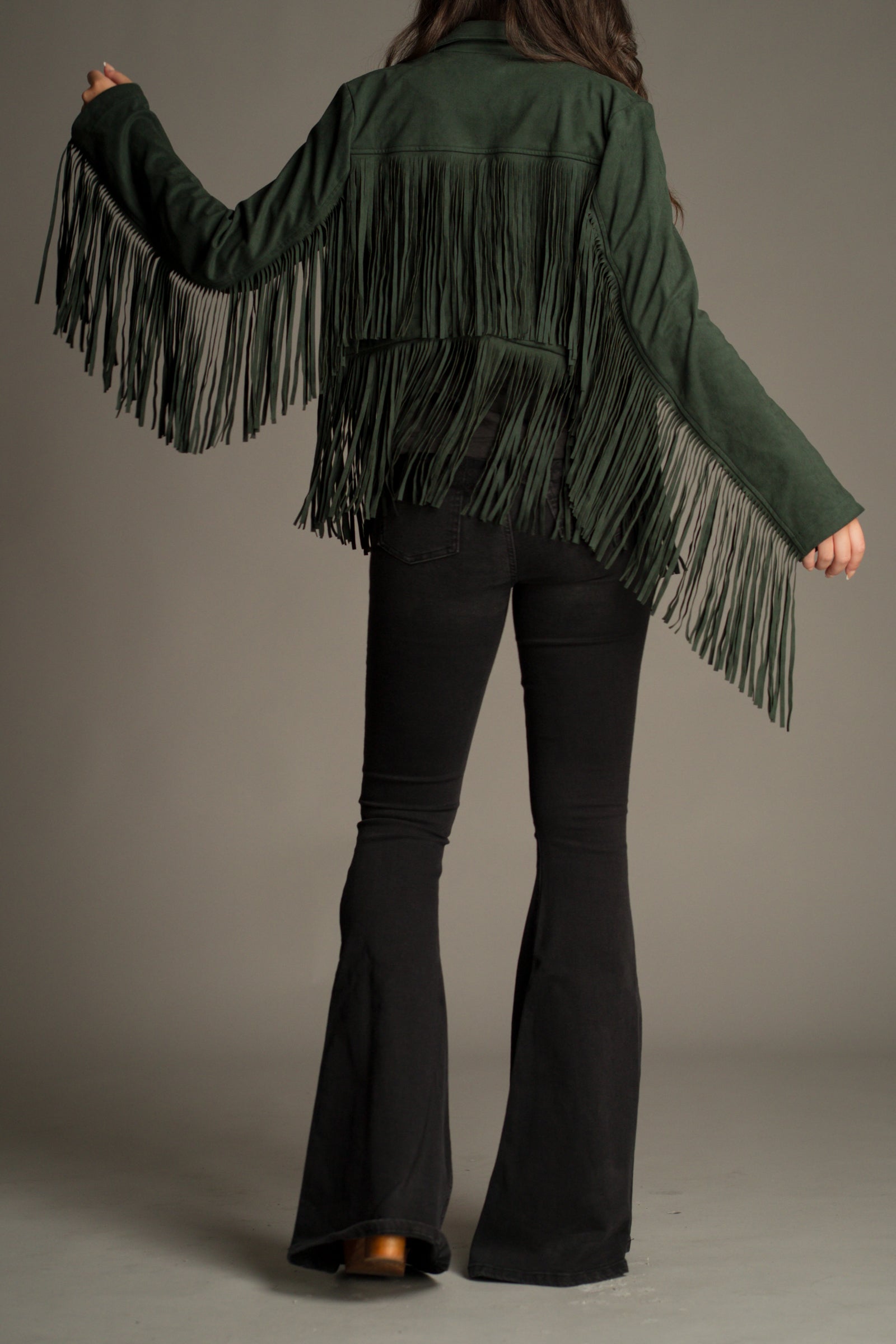 Back view of the Ivy Emerald Green Fringed Faux Suede Jacket showing statement fringe detail.
