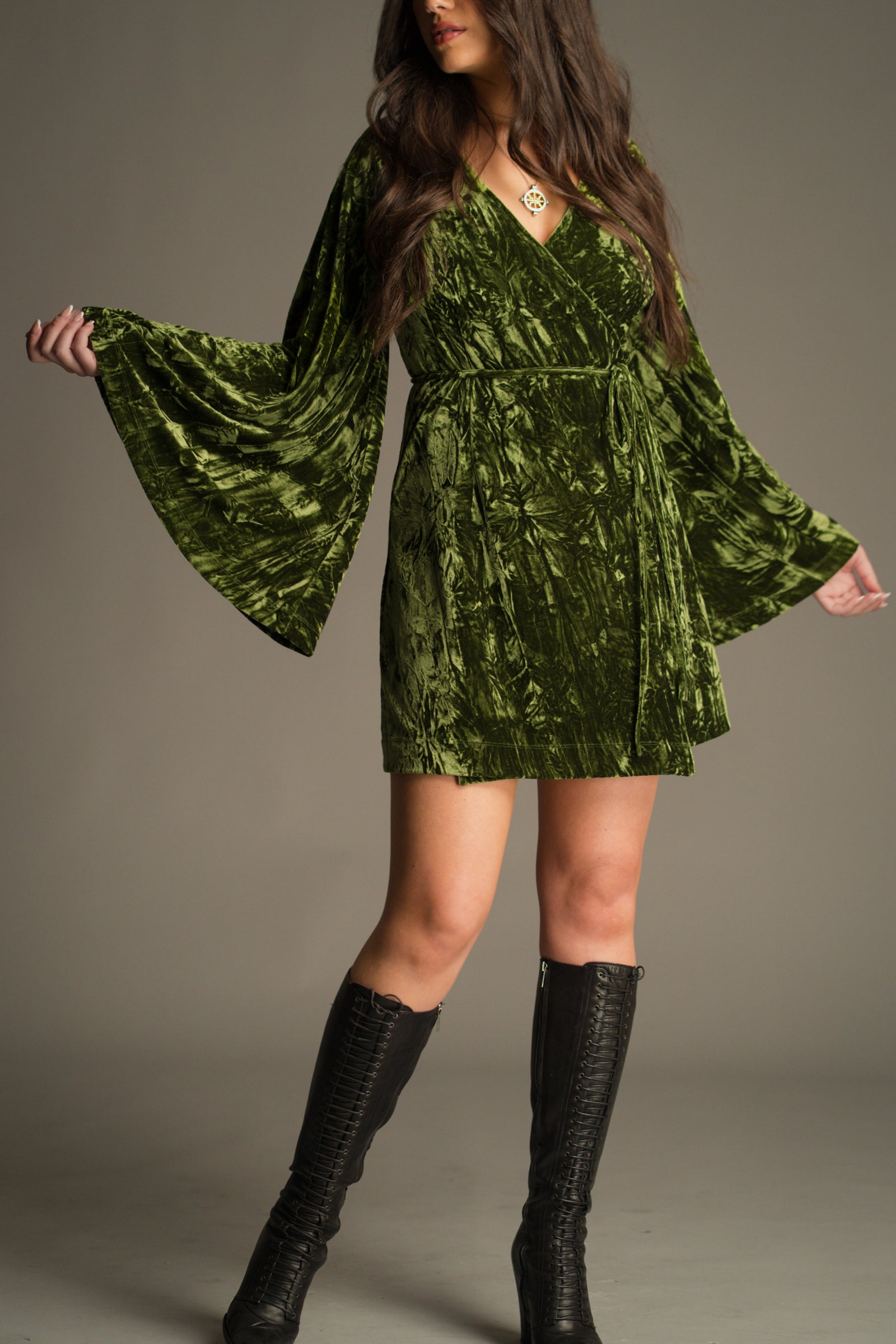 Full length view of the Jaded Olive Crushed Velvet Wrap Mini Dress showing flared sleeves and mini length.