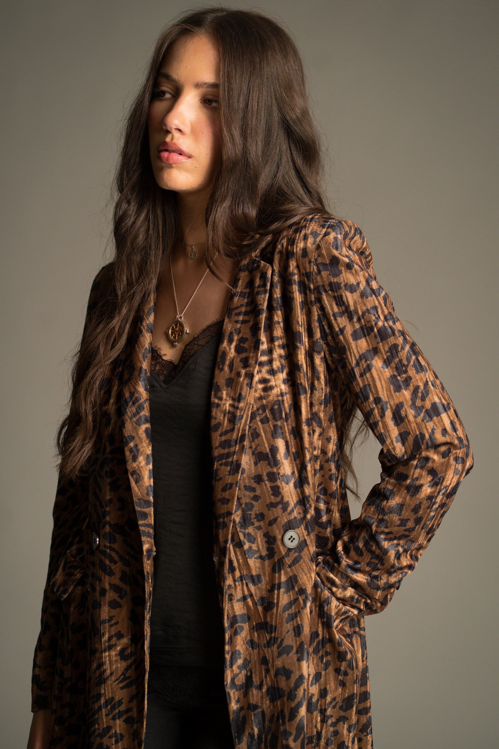 Top detail view of the Jagger Leopard Velvet Duster Coat showing slim lapels and pocket detail.