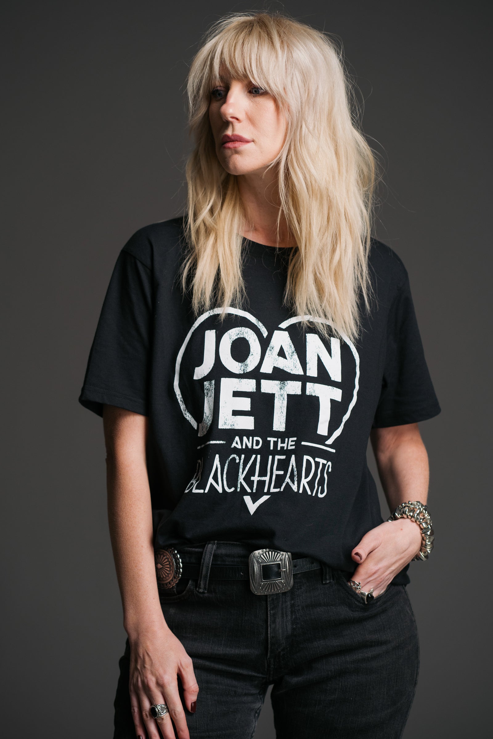 Sara wears Little Lies black Joan Jett and the Blackhearts band tee with bold heart logo graphic in a relaxed fit.