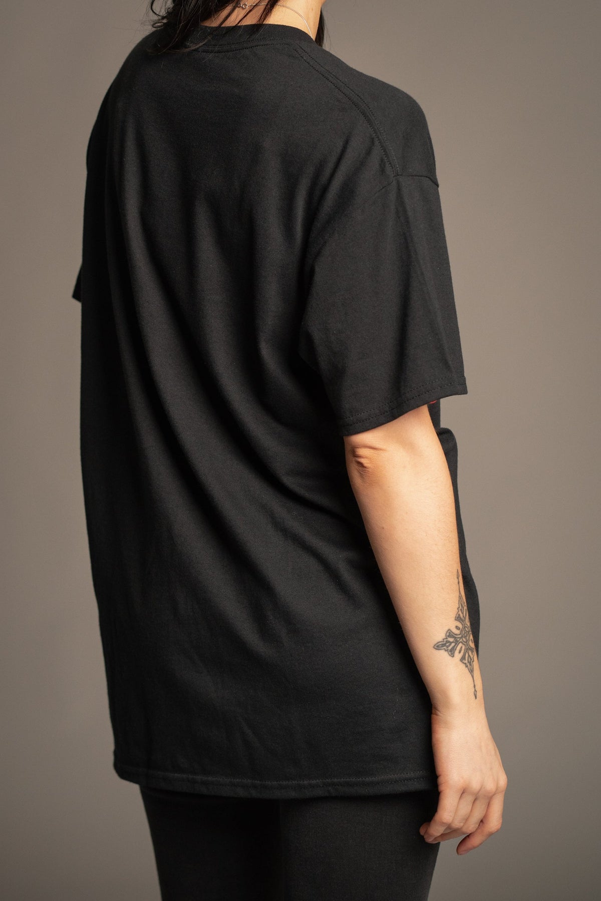 Back view of Victoria wearing the Led Zeppelin 1968 black band T-shirt sized up for an oversized look