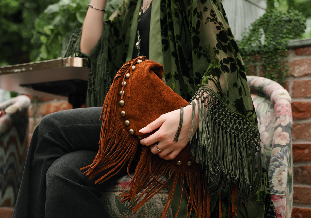 Little Lies Kate studded tan suede fringe shoulder bag styled with Dakota olive velvet burnout kimono featuring tassel trim and bohemian-inspired detailing.