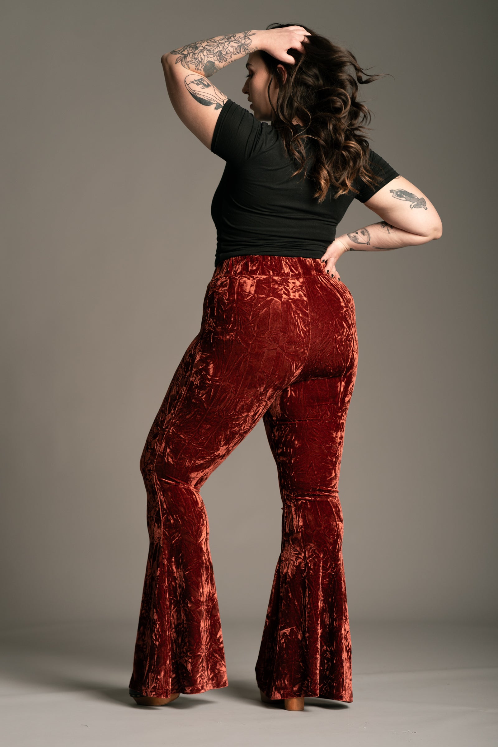 Plus size back view of Hendrix Rust Crushed Velvet Flares in lustrous crushed velvet