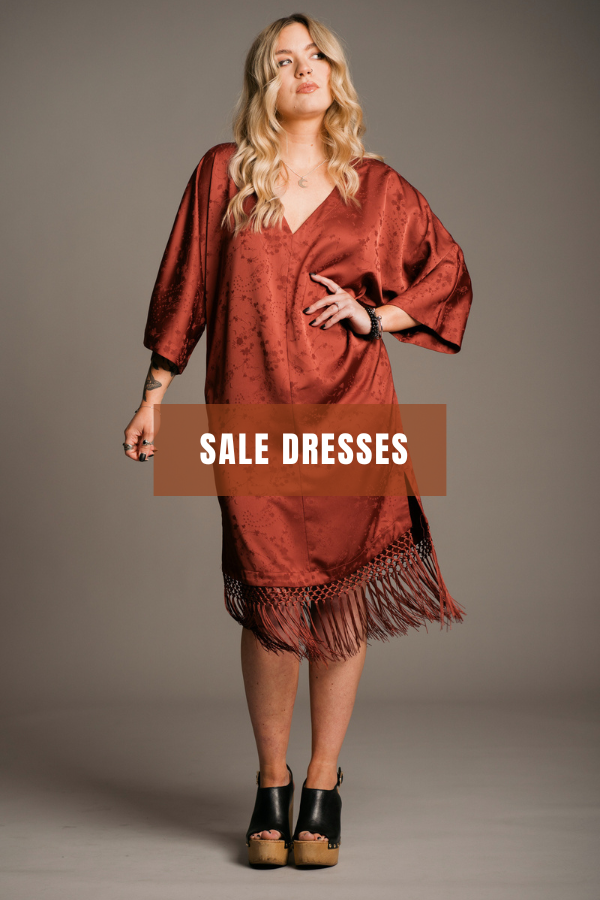Shop sale dresses at Little Lies with up to 60% off. Model wearing Florence Rust Fringed Kimono Dress.