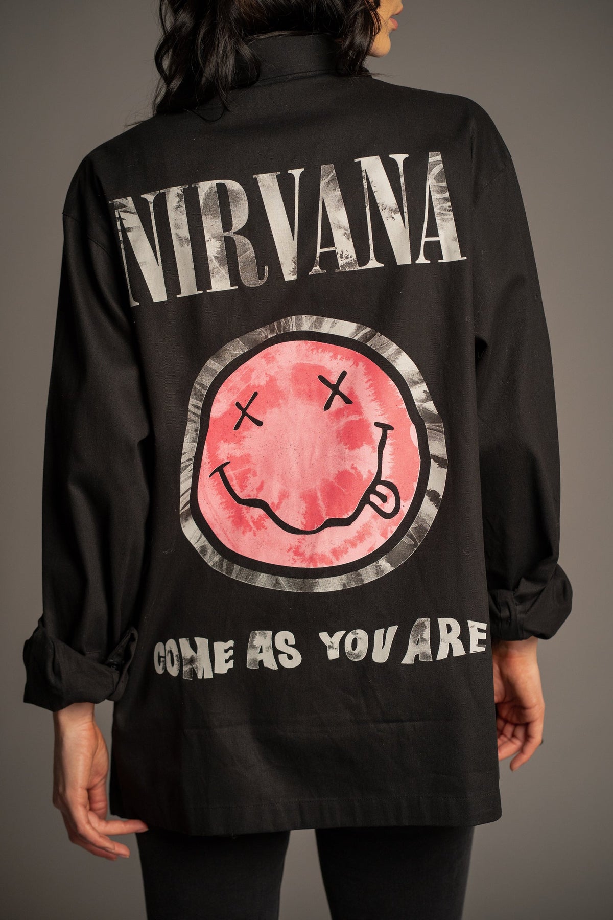 Close-up of the pink Nirvana smiley graphic on the Come As You Are black overshirt