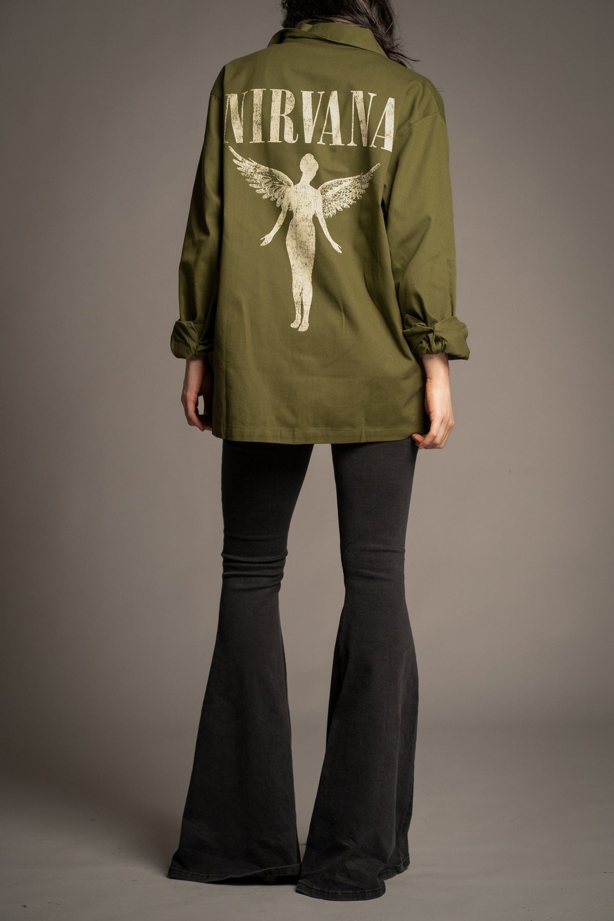 Side view of Victoria wearing the Nirvana In Utero khaki overshirt
