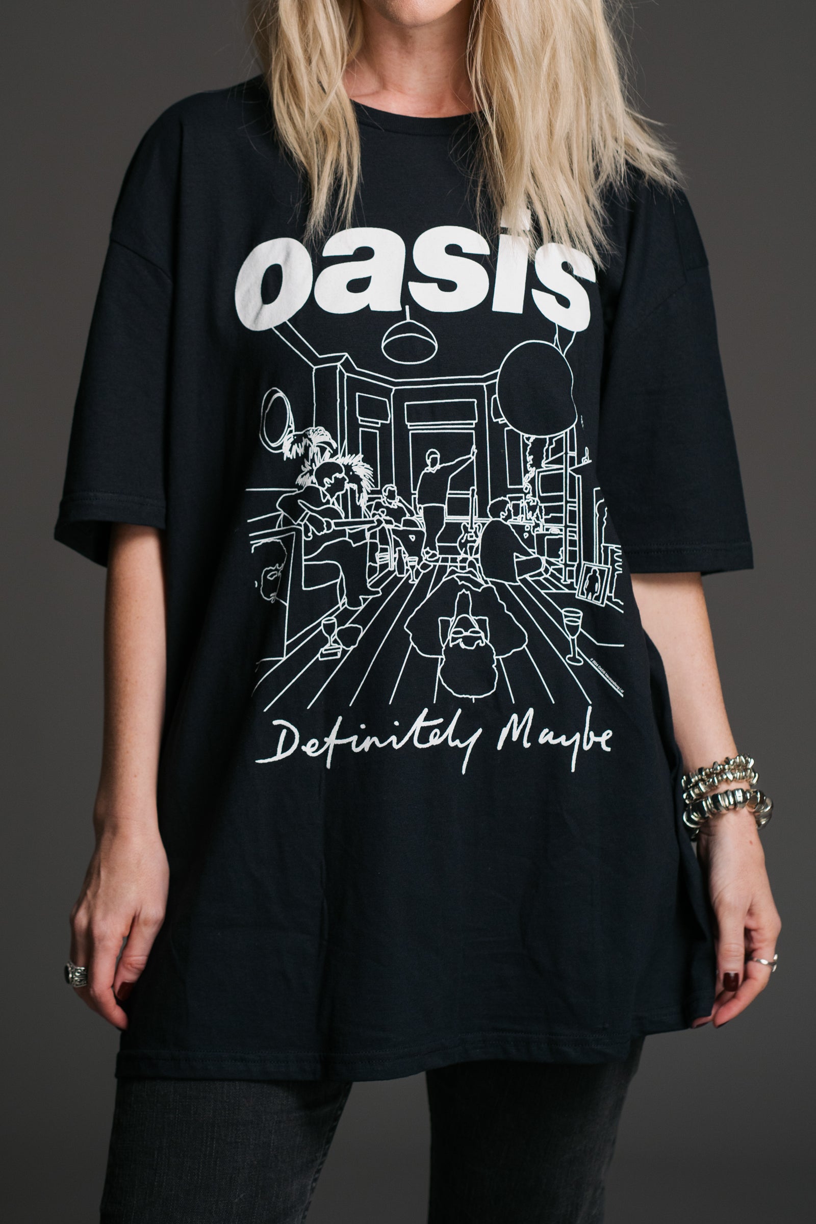 Unisex black Oasis Definitely Maybe graphic t‑shirt by Little Lies featuring bold white Oasis logo and illustrated album artwork detail