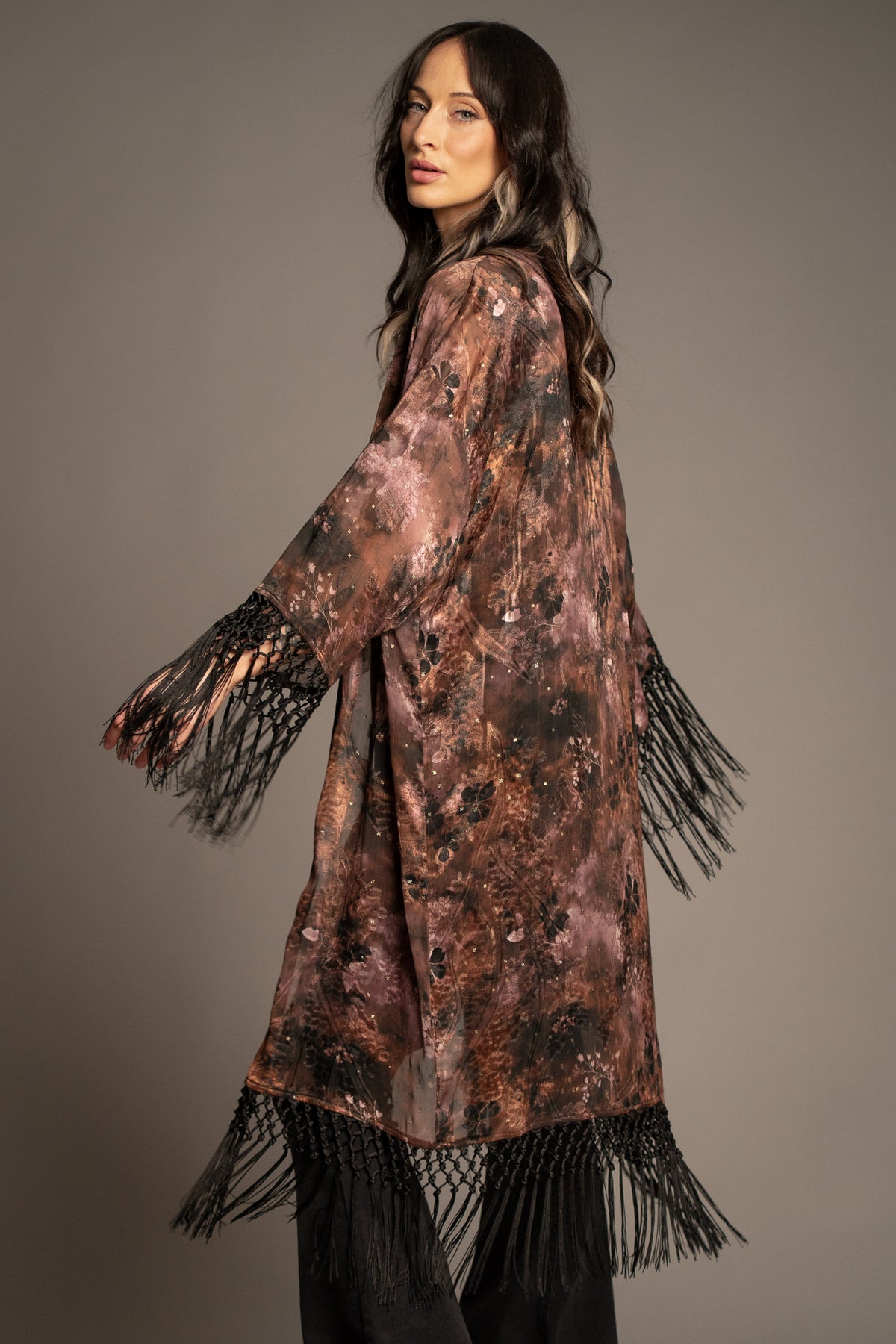Practical Magic kimono back view featuring an antique floral print, flowing silhouette and statement fringe hem