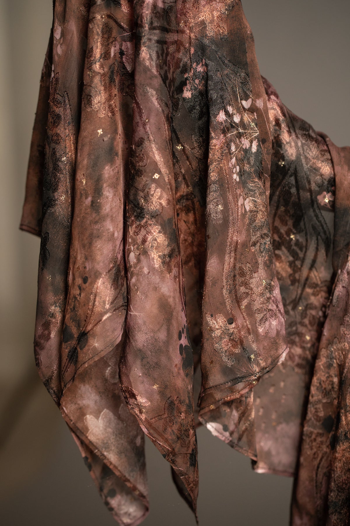 Close-up of Practical Magic mini dress showcasing boho floral print, relaxed silhouette and dramatic draped hanky sleeves
