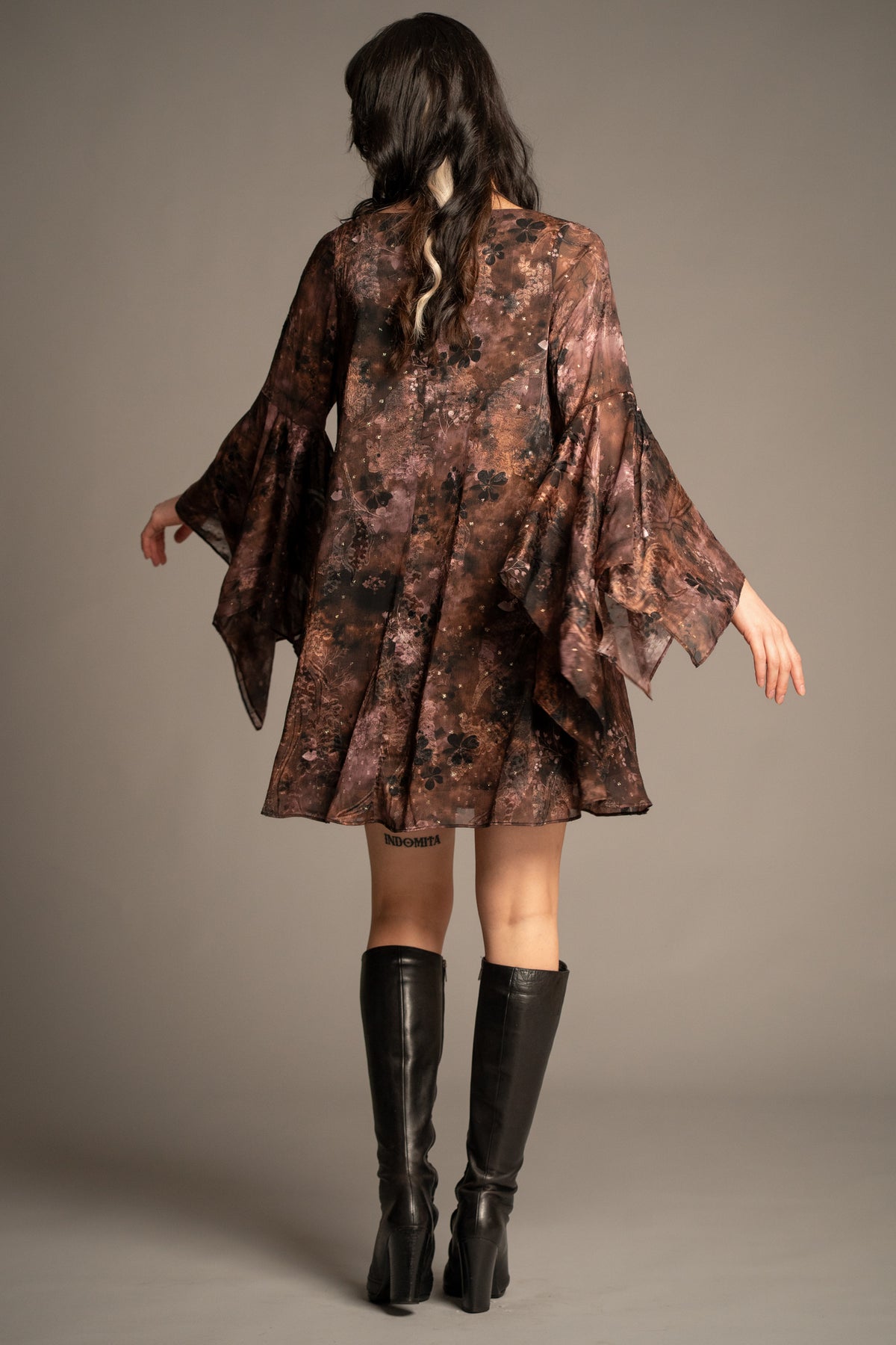 Practical Magic mini dress back view with floaty swing silhouette, floral print and layered hanky sleeves
