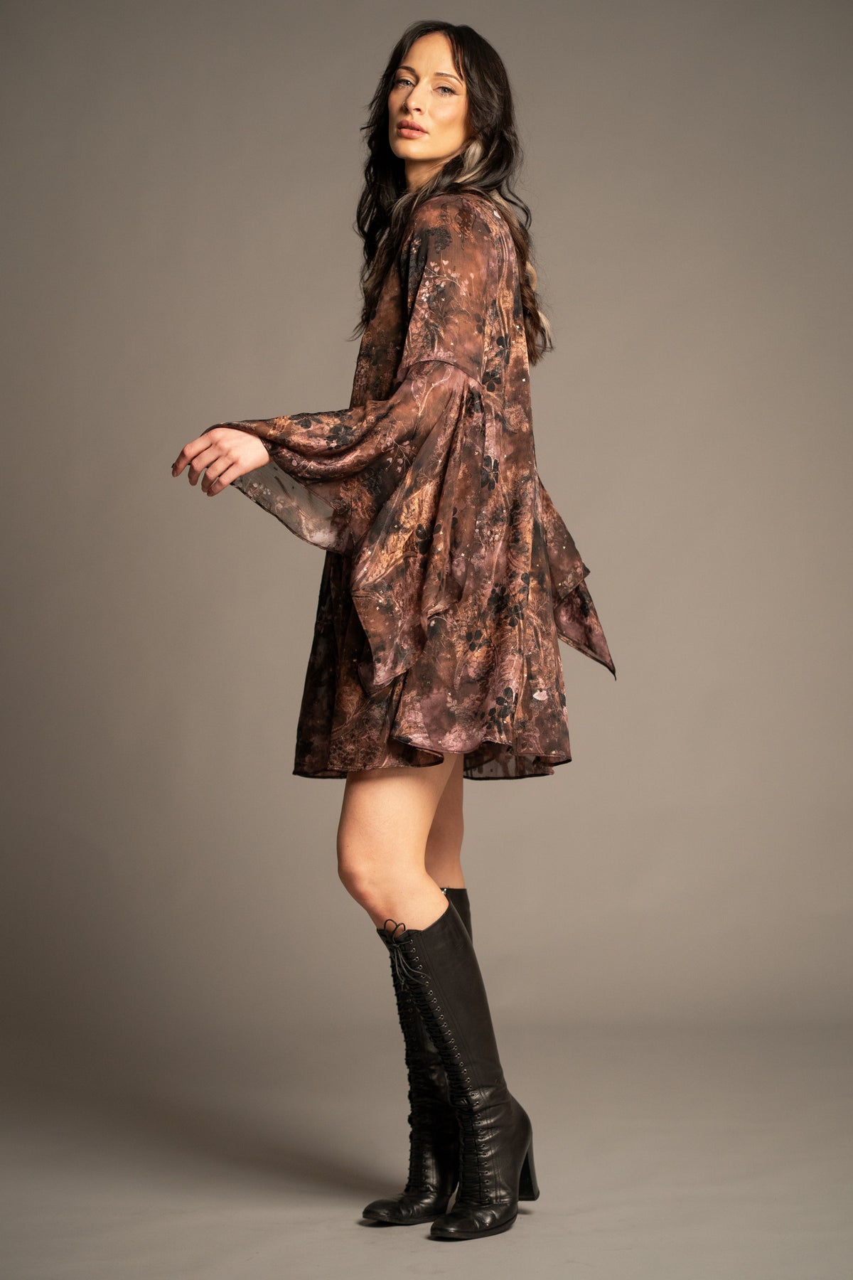 Practical Magic mini dress side view featuring boho floral print, relaxed silhouette and dramatic draped hanky sleeves