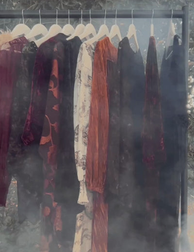 Little Lies Stevie Collection hanging on rail in misty woodland, shrouded in smoke and fog – boho garments in florals, velvets and textured fabrics styled for a Stevie Nicks inspired vibe.