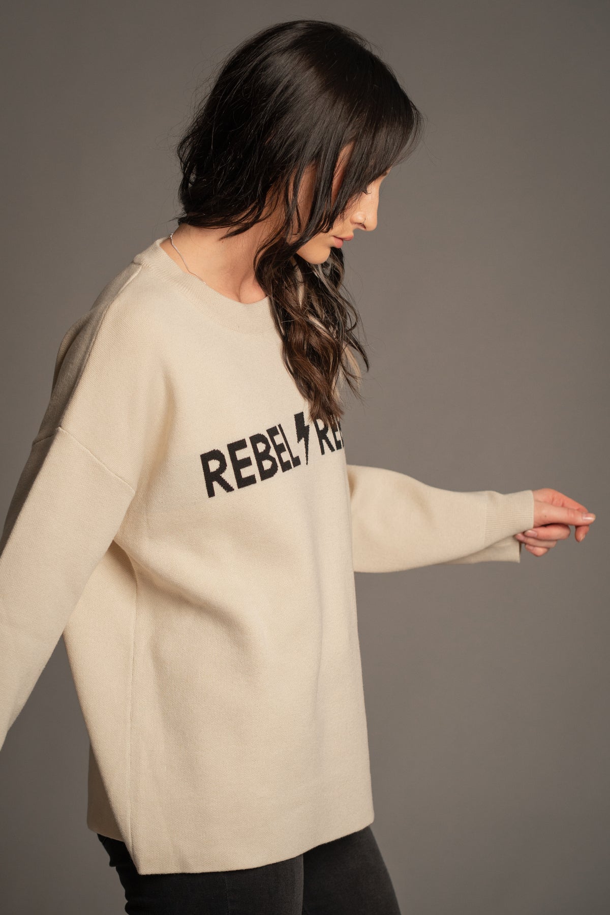 Victoria wearing the Rebel Rebel Cream Graphic Knit Jumper — front view